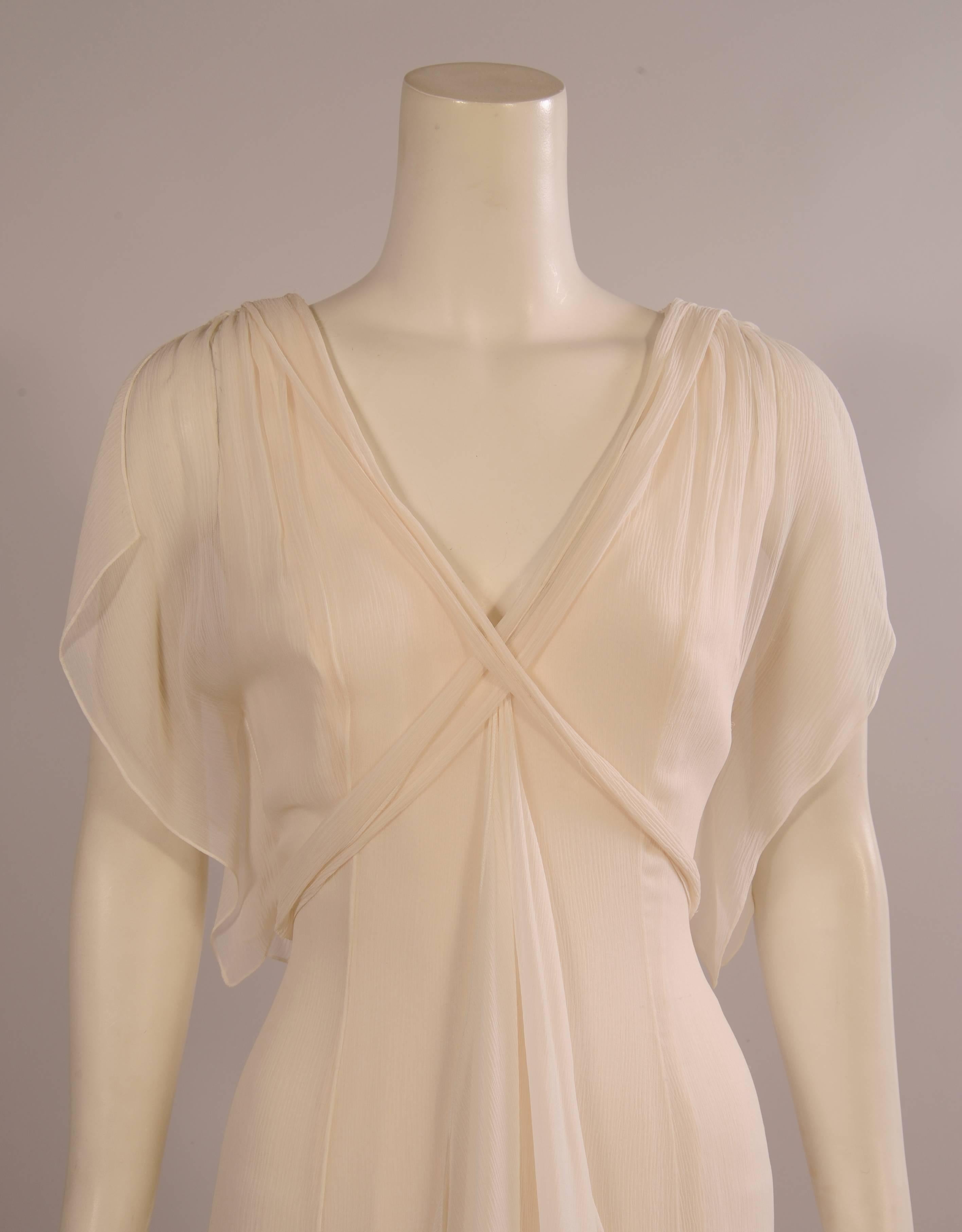 An absolutely gorgeous gown for a big party or wedding, it would look fabulous on a bride too! The silk georgette drapes beautifully from the V shaped neckline in a long floating panel.  Shorter panels begin at the hipline and continue around the