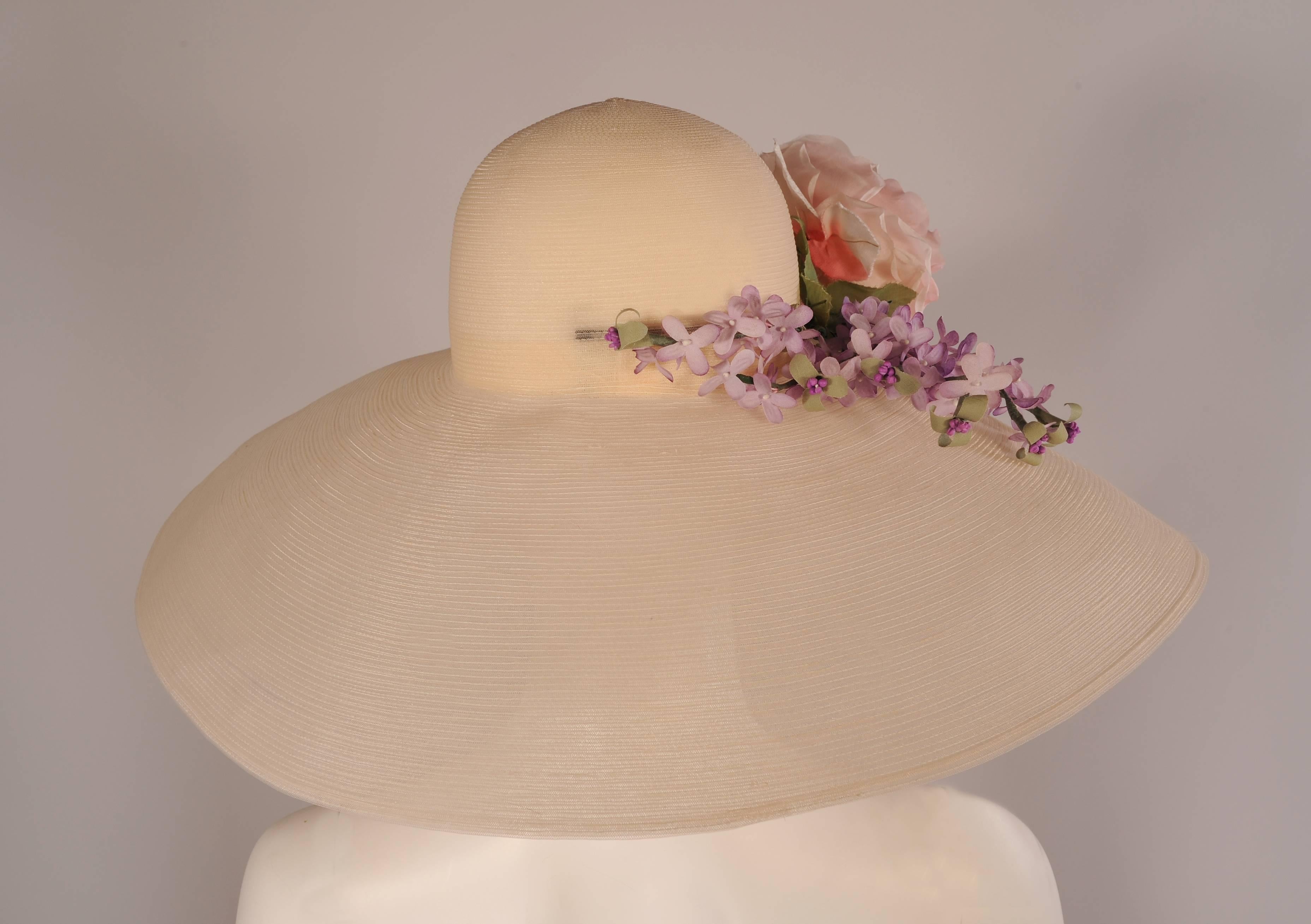 This beautiful ivory horse hair hat has a very generous brim to protect you from the sun or prying eyes, it was custom made for my client by her friend Patricia Underwood.  The hat is elegantly trimmed with a large spray of lavender flowers and a