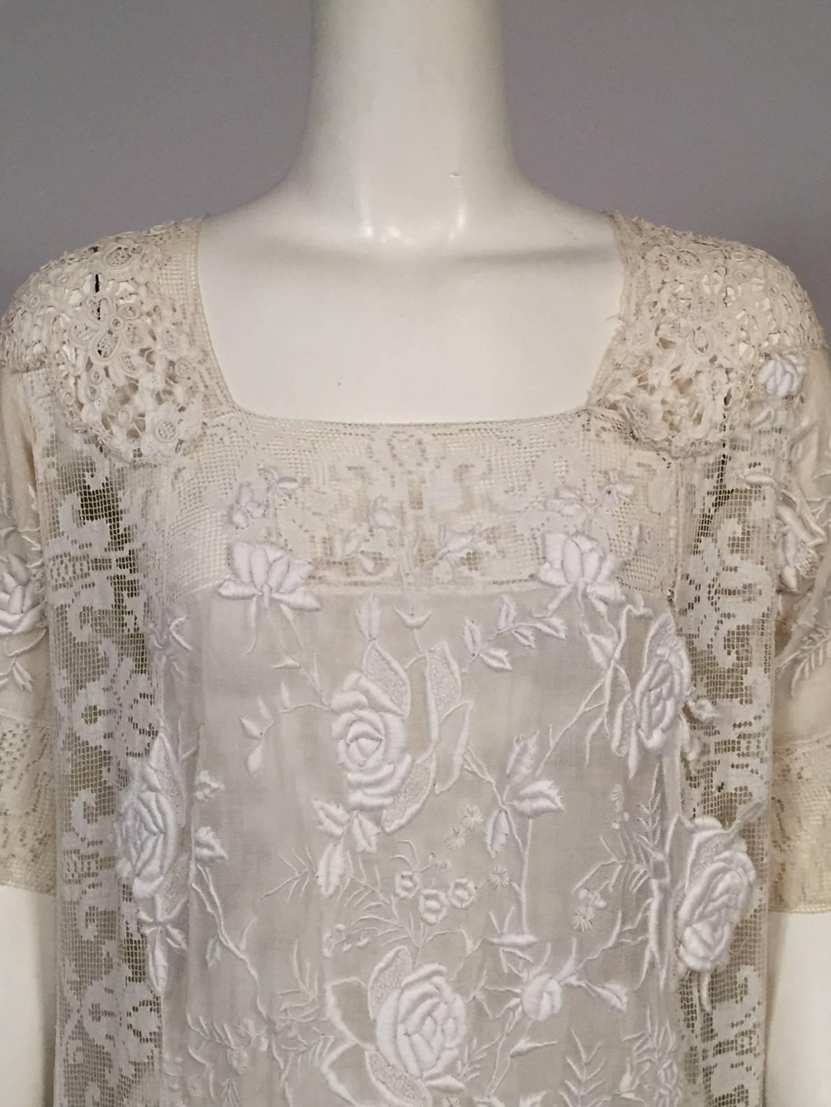A stunning combination of mixed lace and embroidery is combined to make this 1920's chemise style dress. It has a square neckline, short sleeves, a snap closure on the left side of the front. It will fit a range of sizes with the addition of a