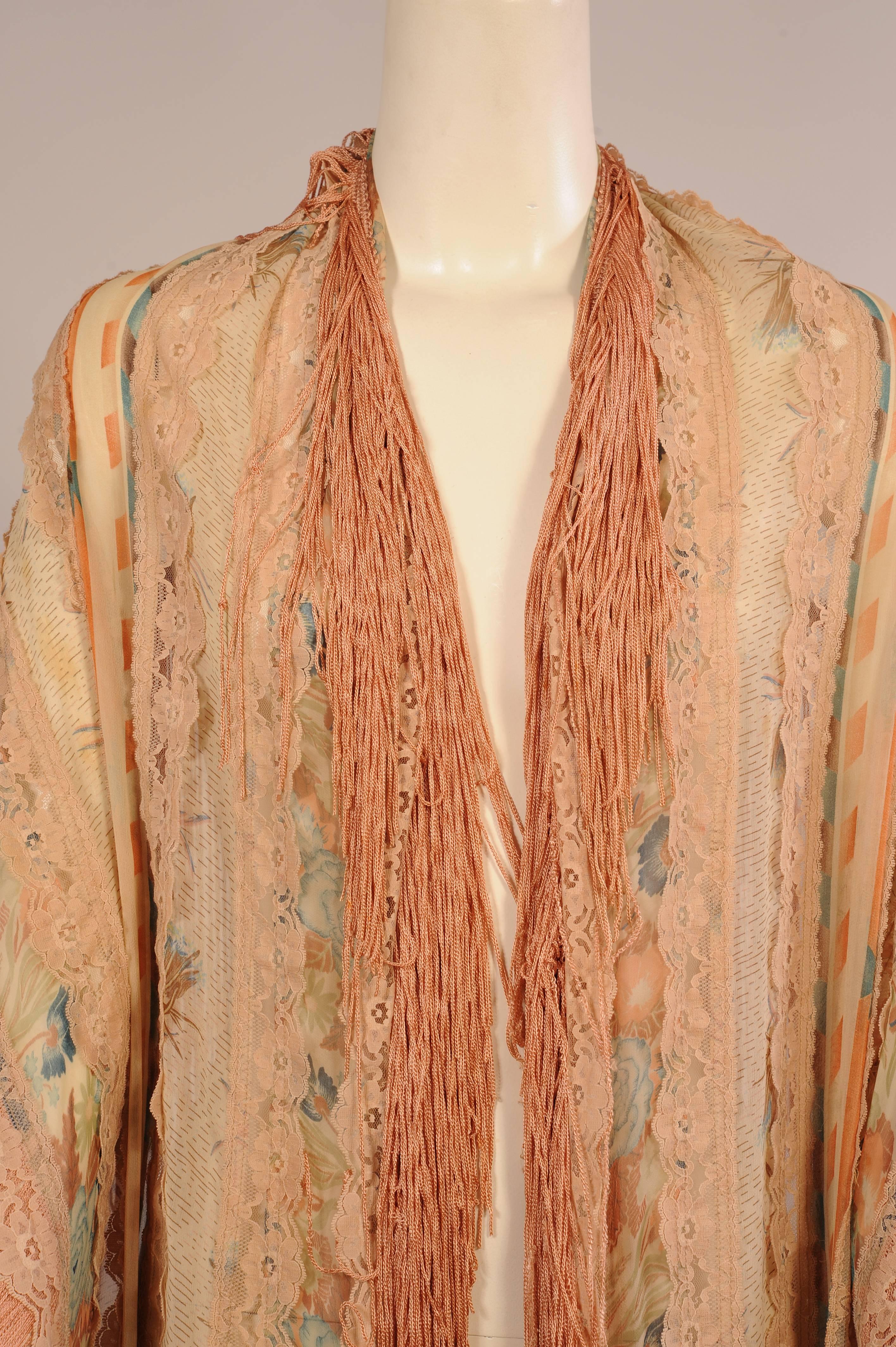 A combination of floral printed and geometric designed chiffon fabrics alternate with bands of cream lace. This lace edges the shawl just above the pale coral fringe on all four sides. It is in excellent condition.
Measurements;
Length 84