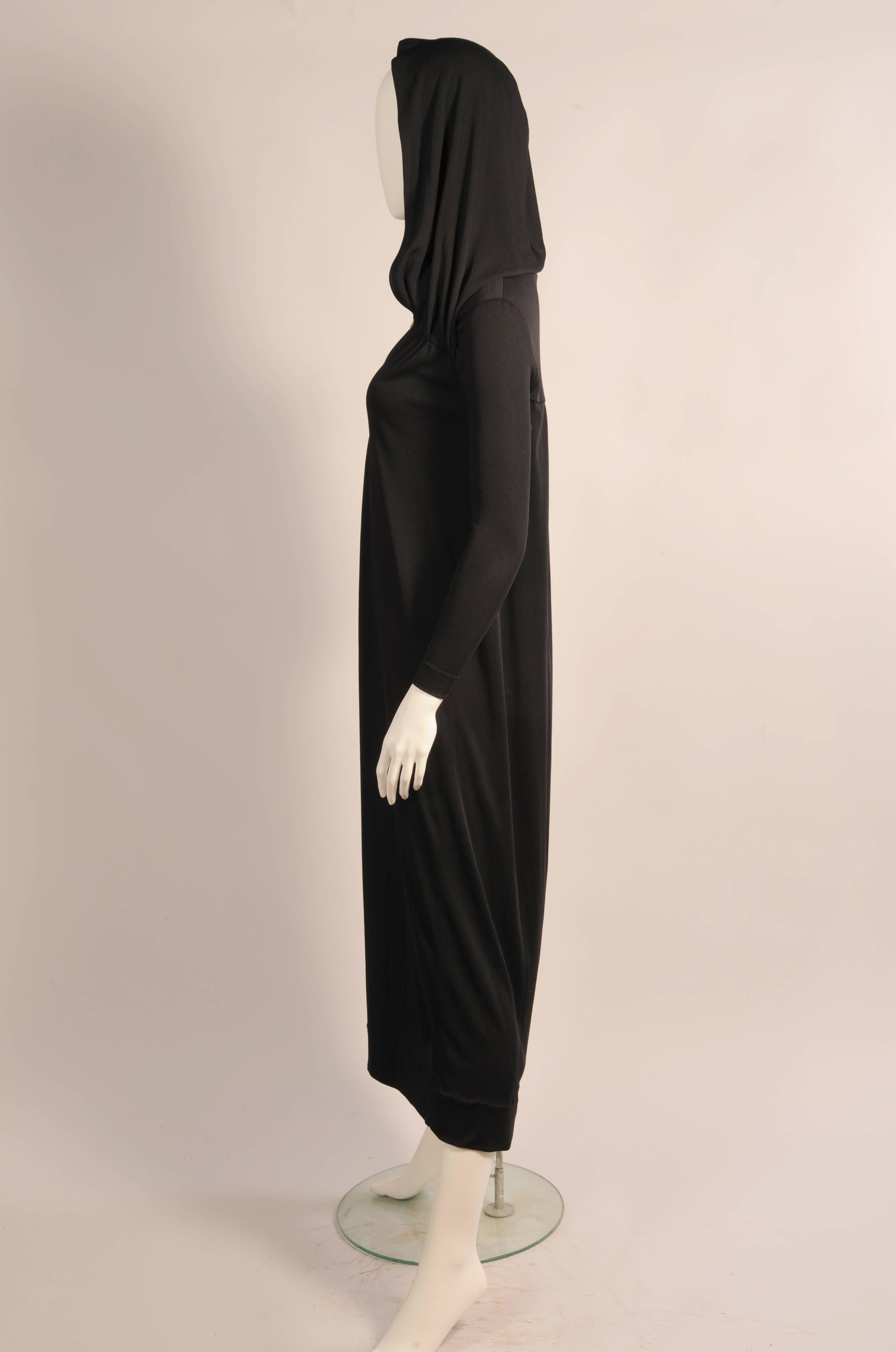 This sleek black dress would be absolutely perfect to wear the exhibition Heavenly Bodies, Fashion and the Catholic Imagination currently on view at the Metropolitan Museum. The strong religious overtones in the hooded dress could be inspired by the