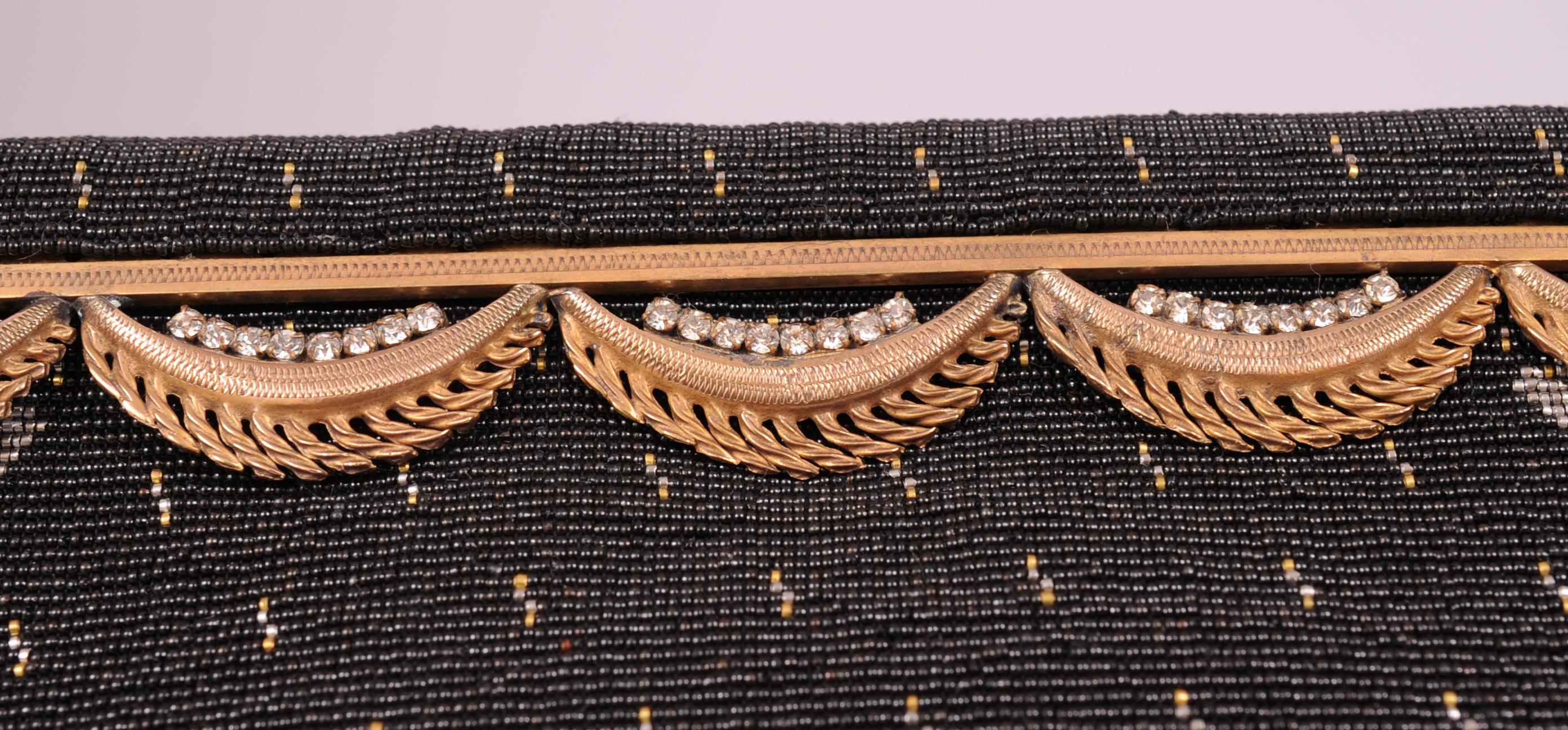 Langlois & Jargeais< Paris are the creators of this stunning black beaded  evening bag. The workmanship is truly breathtaking. The very smallest micro beads are used in shades of black, gold, silver and copper all done by hand in France. The bag has