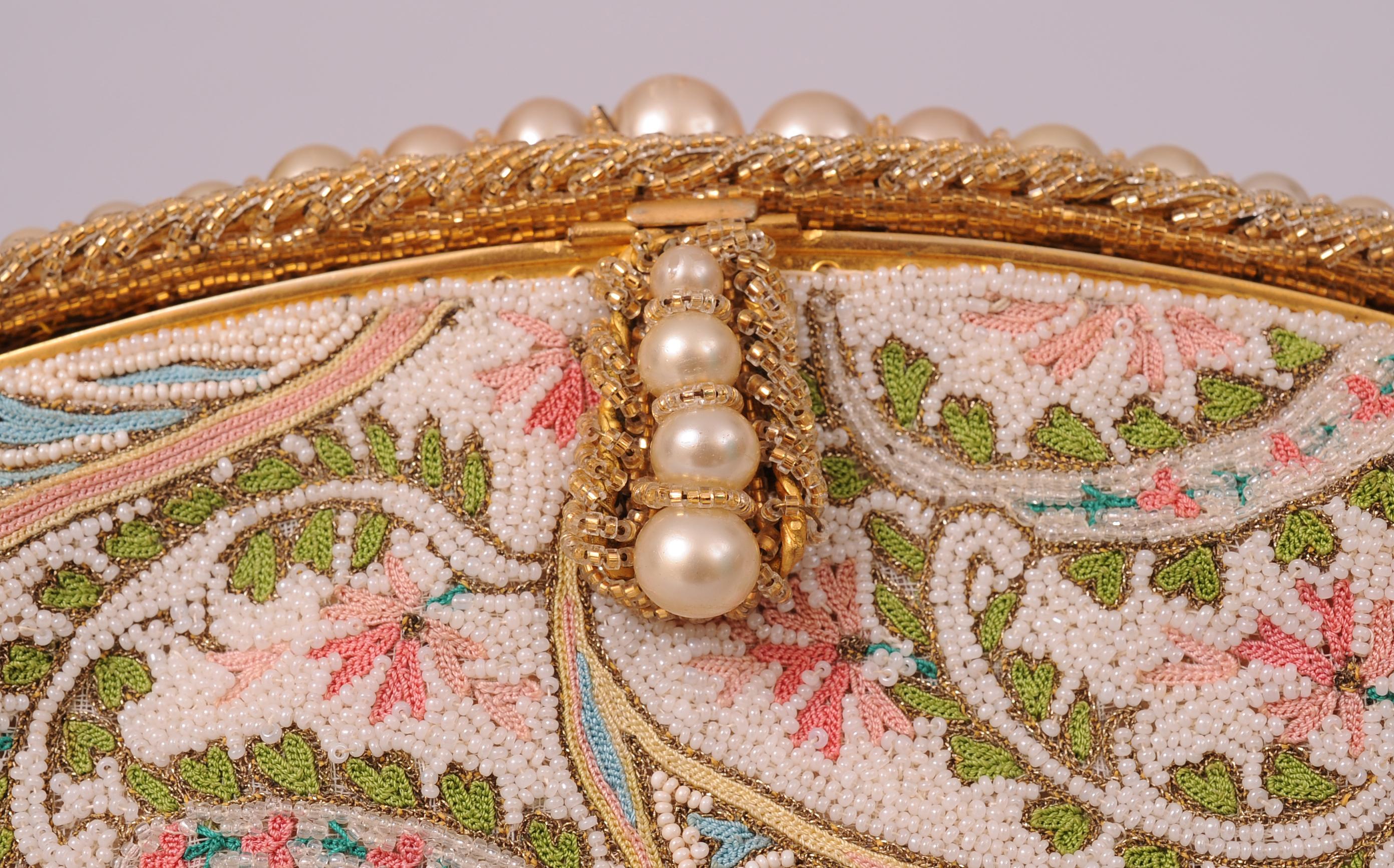 This is the most beautifully beaded and embroidered Josef bag that I have ever offered for sale. It is completely hand beaded in France with white and pearl caviar beads forming the background for the beautiful pastel and gold metallic embroidery.