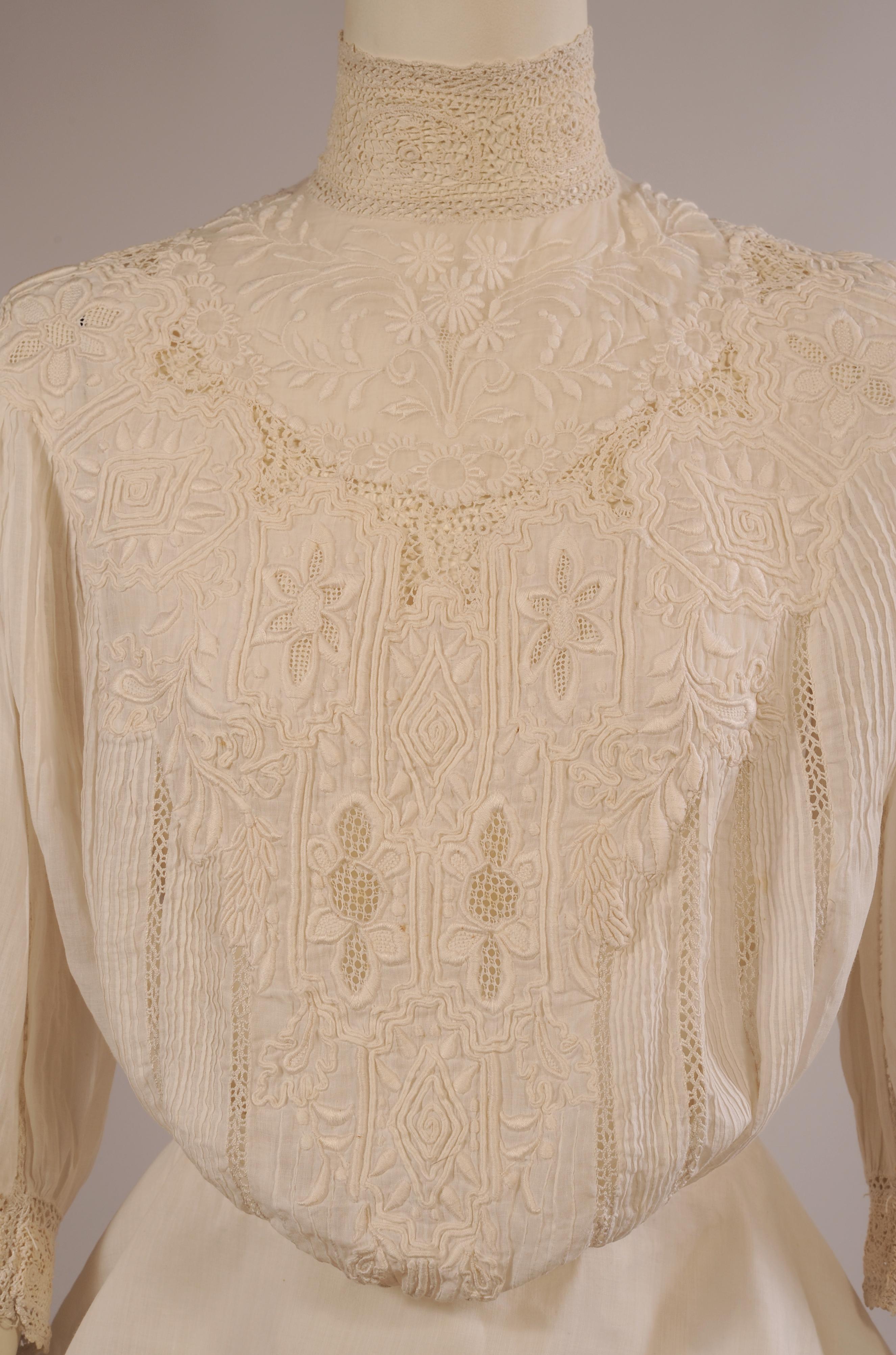 This blouse has it all, Irish lace collar and cuffs, hand embroidery, lace insertion, drawn work, soutache and pin tucking. The sleeves and the back of the blouse repeat the work on the bodice. There are hidden mother of pearl buttons at the center