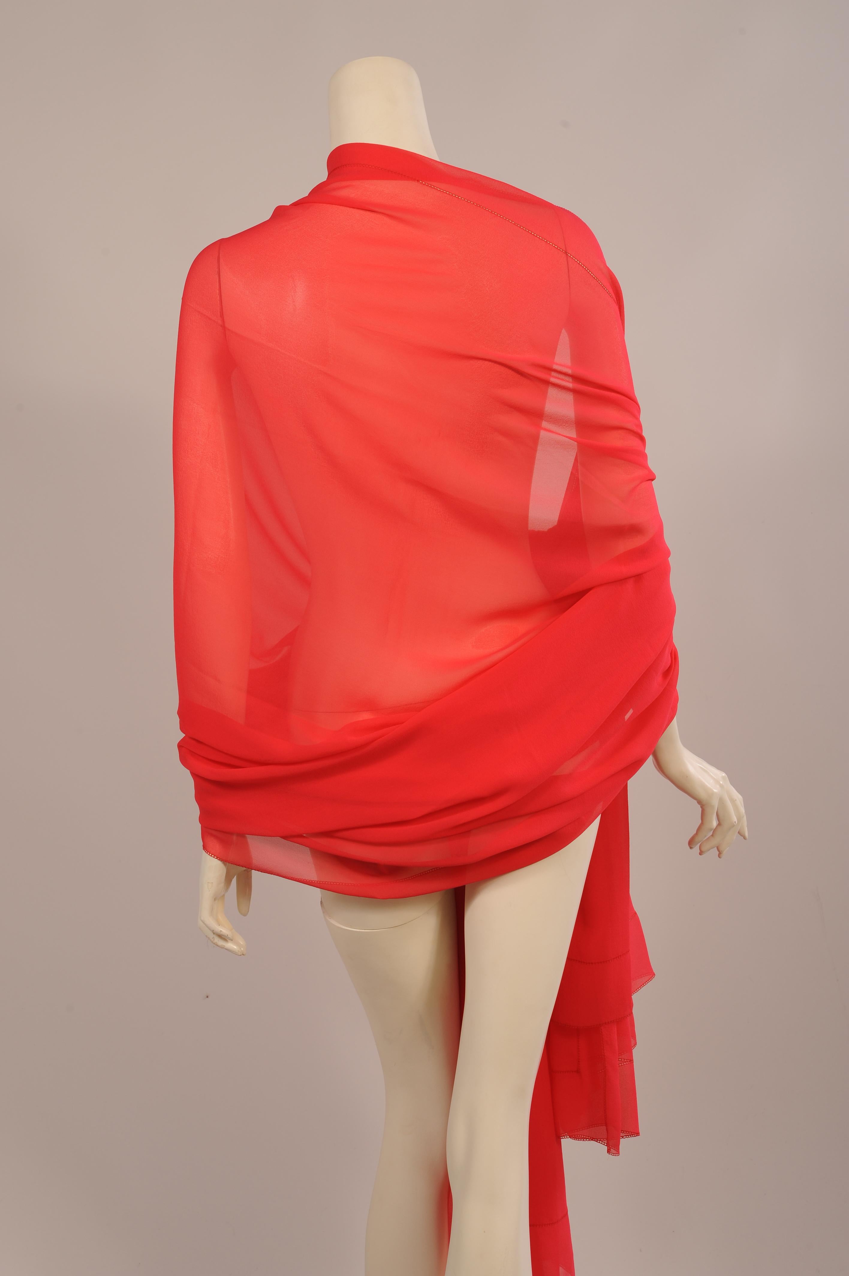 The most beautiful color, not quite coral but a little less than red, this very large silk chiffon shawl has a wide border of the same fabric with faggoted edges on all sides. This shawl will add that 