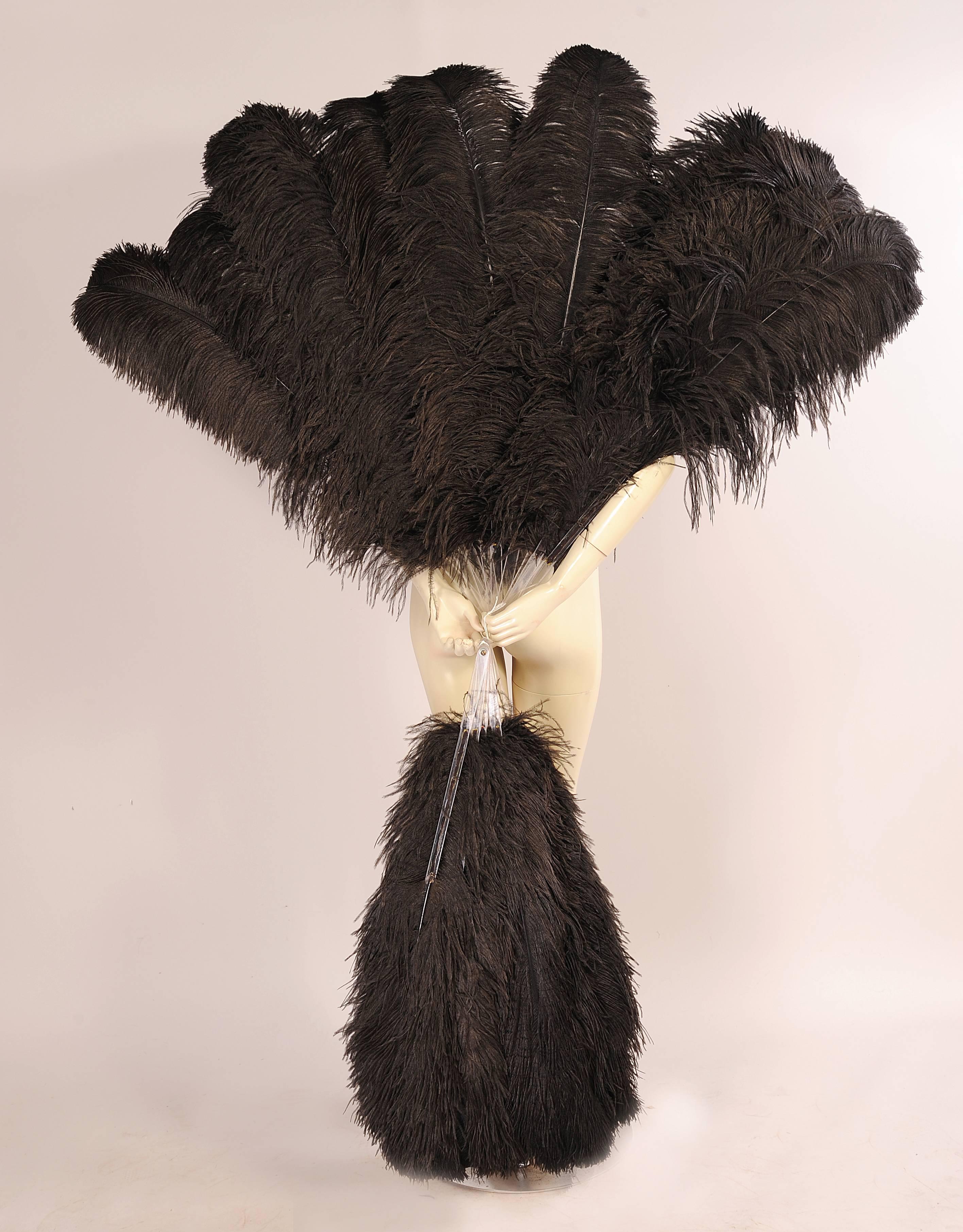 From the Paris atelier of the late Patrick Kelly these oversized Lucite and black ostrich feather fans are just so glamorous.  They were used on the runway during the Autumn Winter 1989 collection. The Lucite sticks almost disappear into the