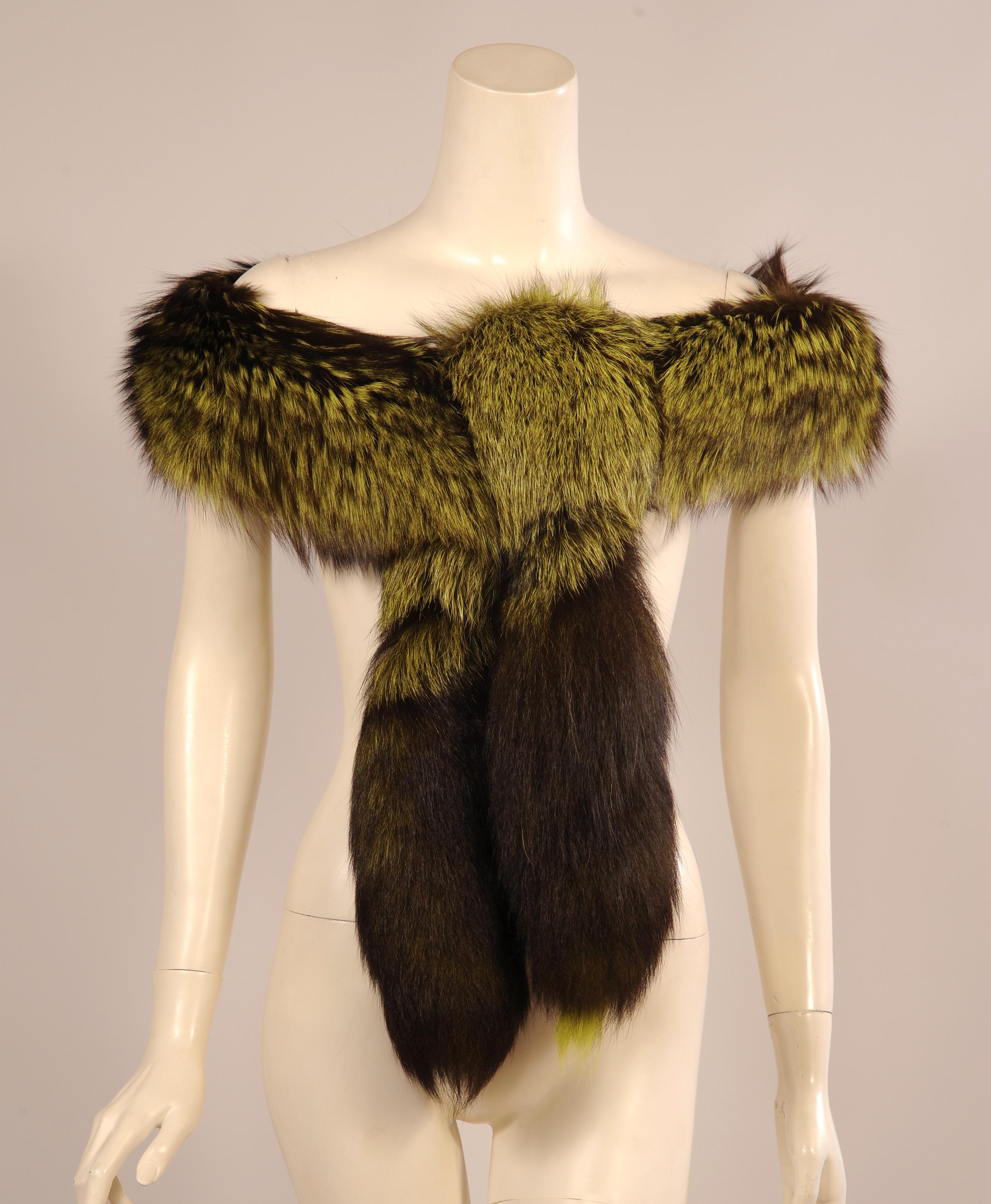 Bright green dyed fox stands out against the darker background making this Birger Christensen stole a very dramatic fur wrap. It is lined with black velvet and both ends are finished with a fox tail. It is in excellent
