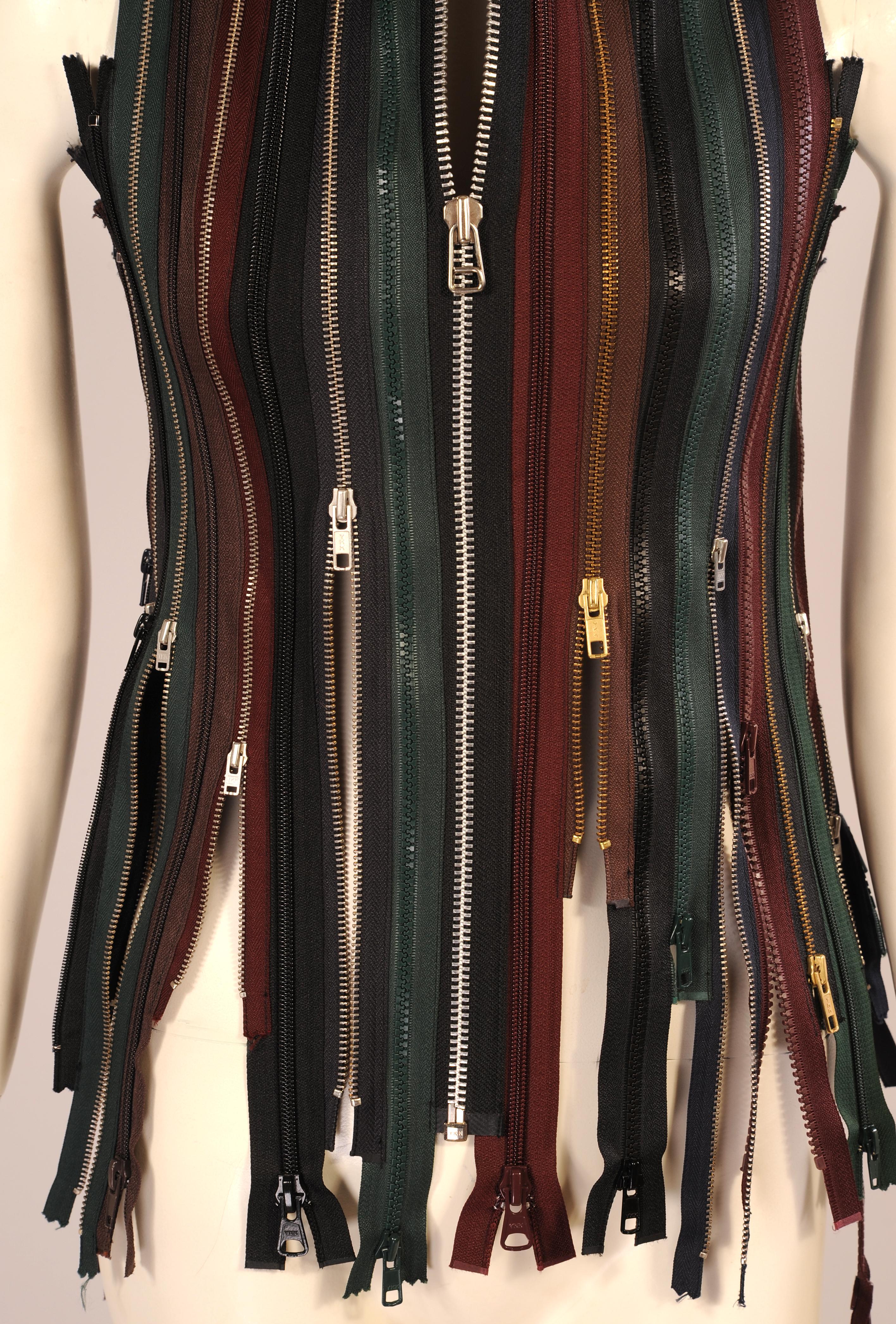 A very unusual and witty design this vest is completely made form zippers in black, navy burgundy and green. 
It is in excellent condition and comes from the first Margiela Artisanal collection.
Measurements;
Bust 34