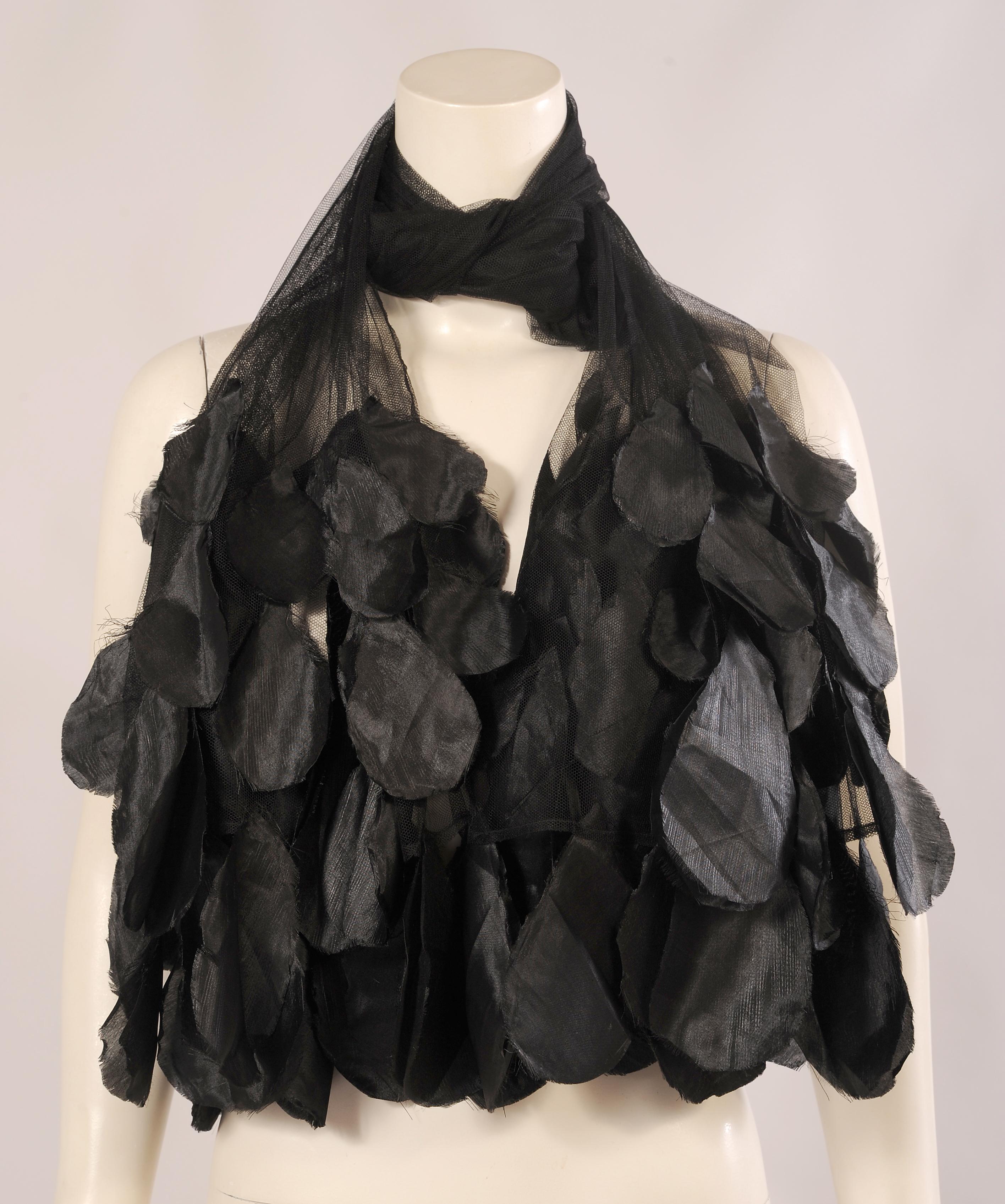 This ultra feminine tulle shawl is embellished with black silk flower petals at each end. The tulle is in perfect condition and one size fits all.
Measurements;
Length 84