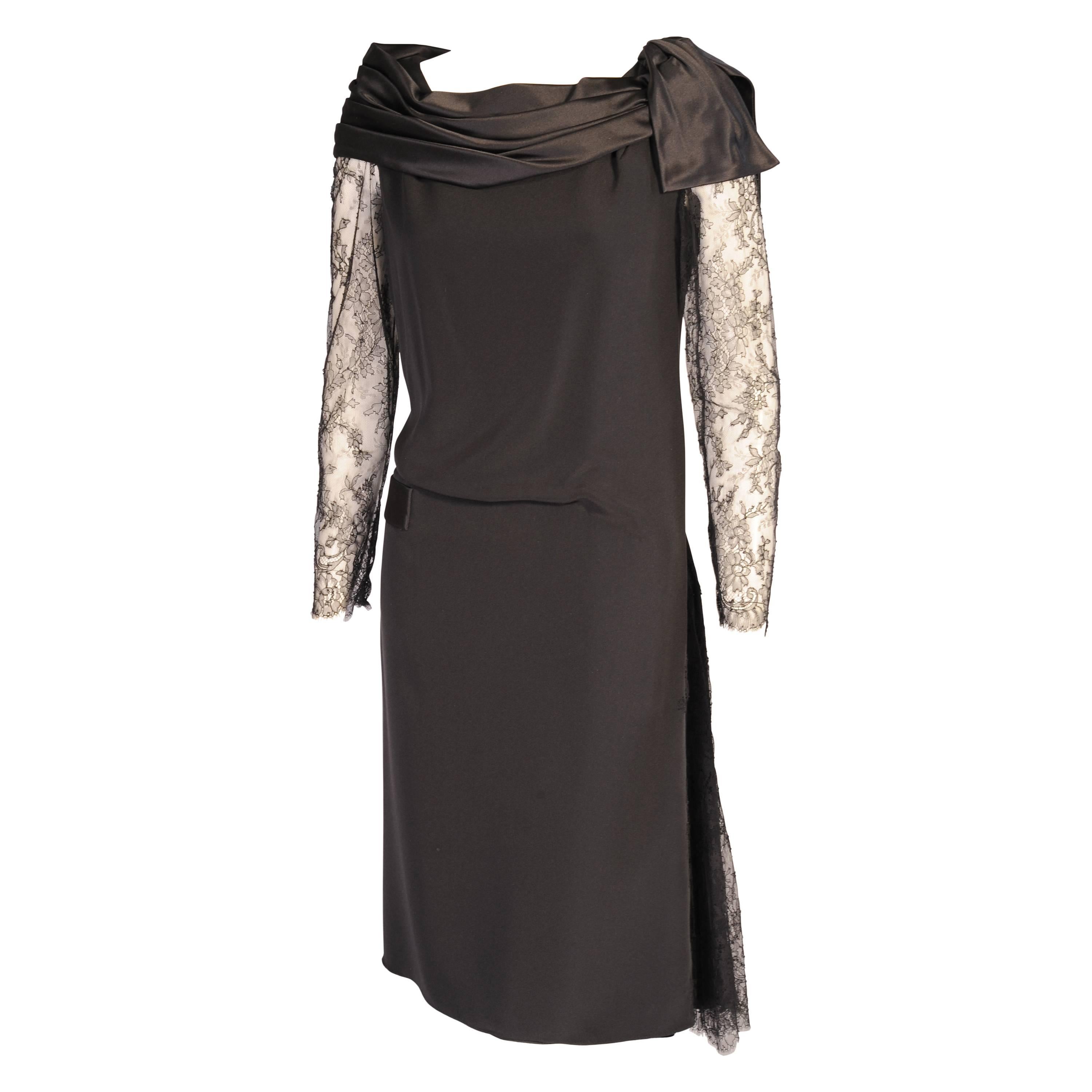 This elegant haute couture dress designed by Christain Lacroix can be worn in two different ways. There is a sleek black silk sheath with a black silk satin band and bow on the bodice. There is a matching satin band on the right hip at the dropped