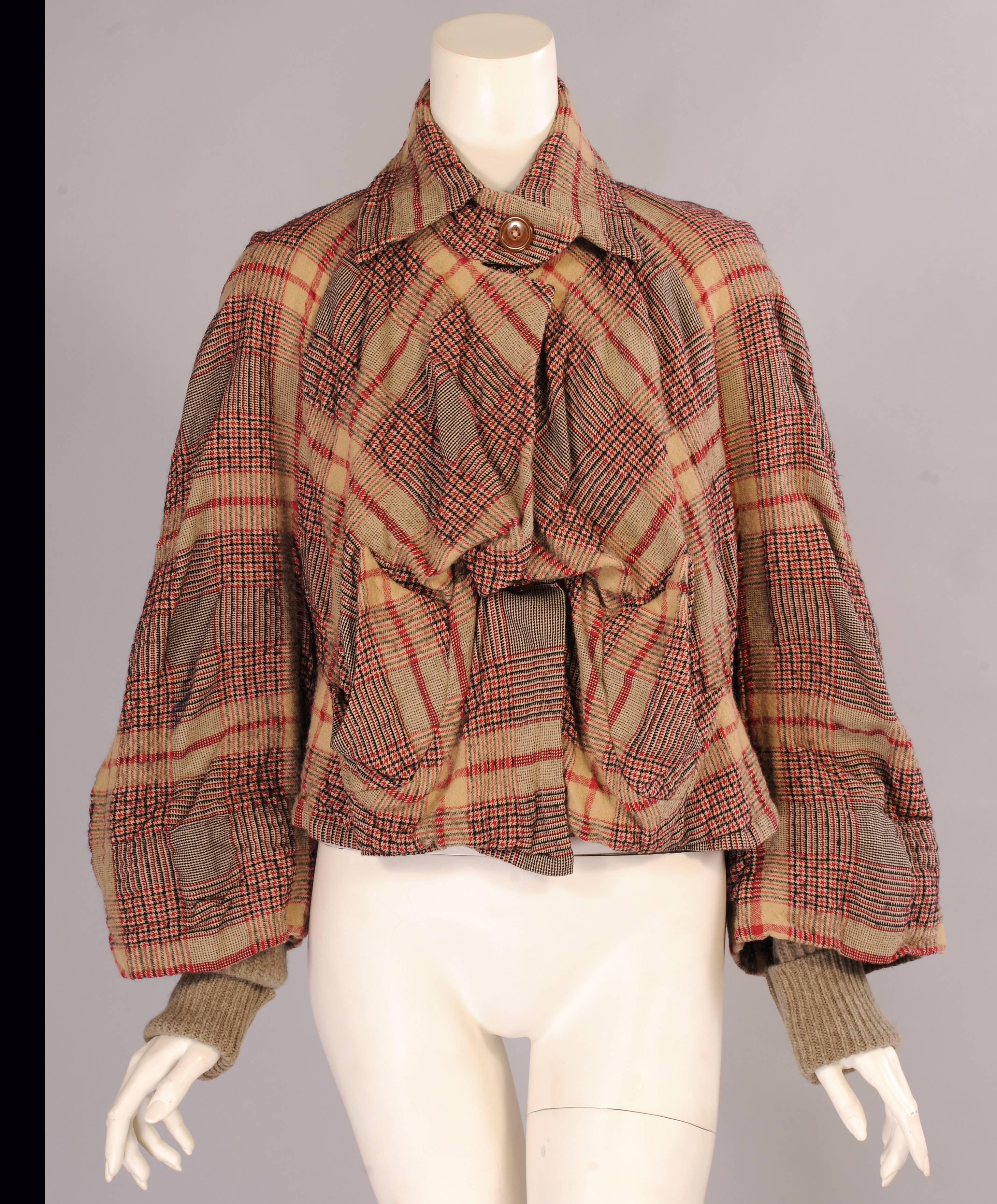 A blend of cotton and wool is used for this plaid jacket from Vivienne Westwood
that  can be worn open or buttoned up. There are two pockets and the full sleeves have a sweater knit half sleeve. The jacket is in excellent condition and it is marked
