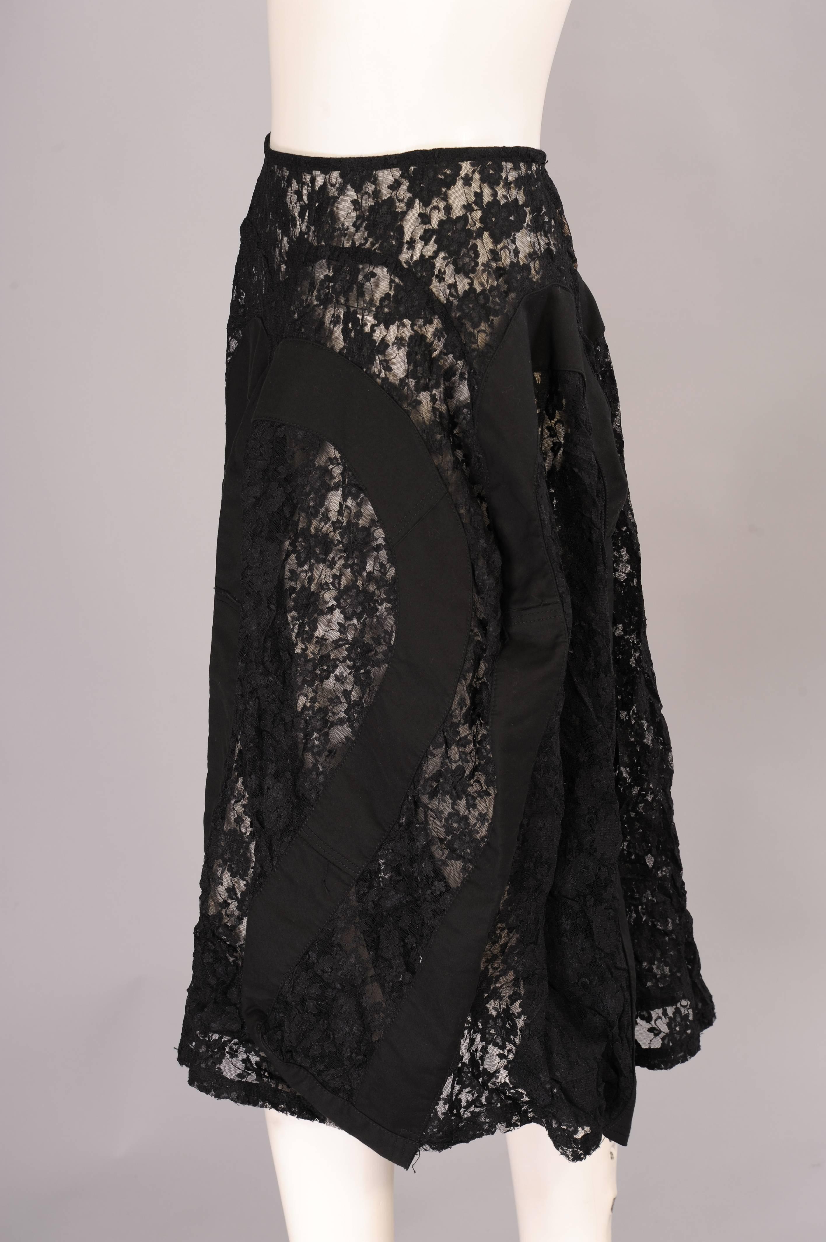 Black floral lace is combined with wide bands of black cotton creating unusual shapes and angles in this skirt designed by Junta Watanabe. It is in excellent condition and appears unworn.
Measurements;
Waist 2"
Length 30"