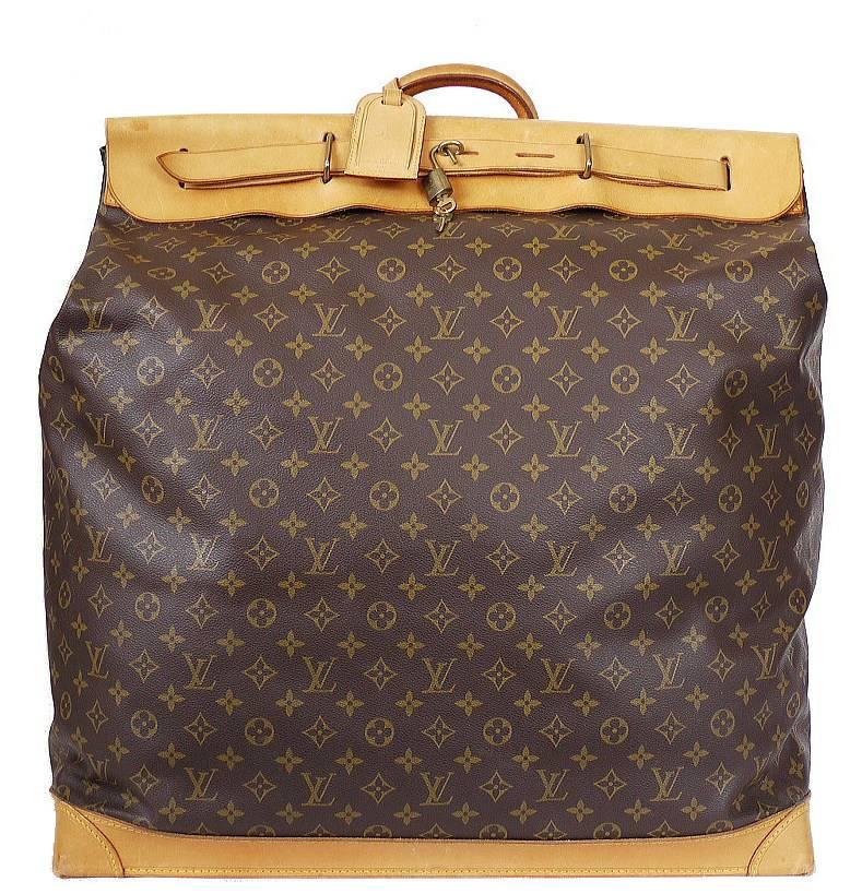 Louis Vuitton Monogram Steamer Bag 55 Travel Bag in very good vintage condition. Special order item. This travel bag in Monogram Canvas offers a large storage space. Its base features protective feet and a leather strap makes its closure more