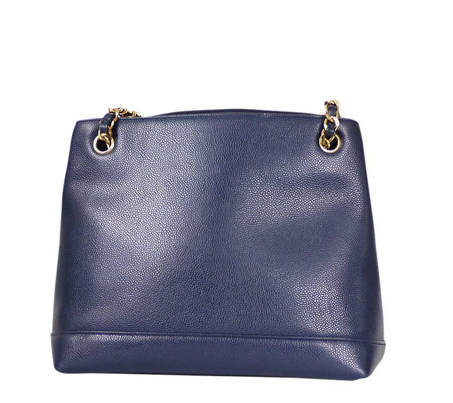Vintage Chanel navy blue caviar shoulder bag. Beautiful bag from 1994 collection. Features a multiple compartments including central zipped compartment, 2 zipped interior pockets and comfortable flat leather strap. This functional vintage Chanel