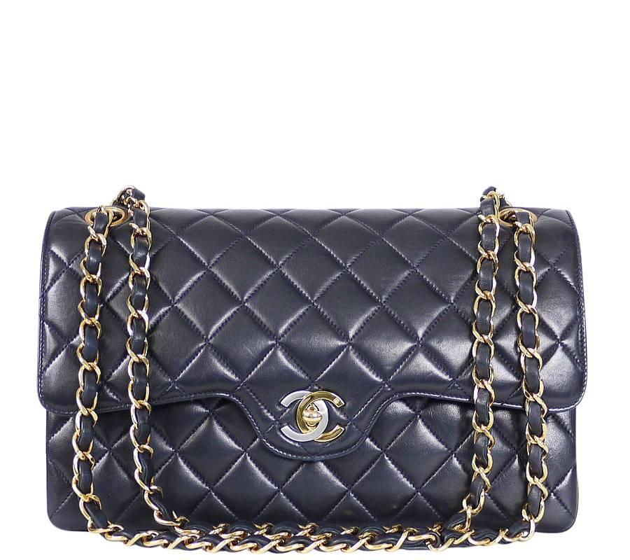 Chanel navy lamb skin  2.55 classic flap bag. Made in early 1990's as Paris limited edition. Hard to find rare vintage double flap classic. Features a double flap with multiple storage compartments, Gold x Silver CC turn lock closure.

    Main
