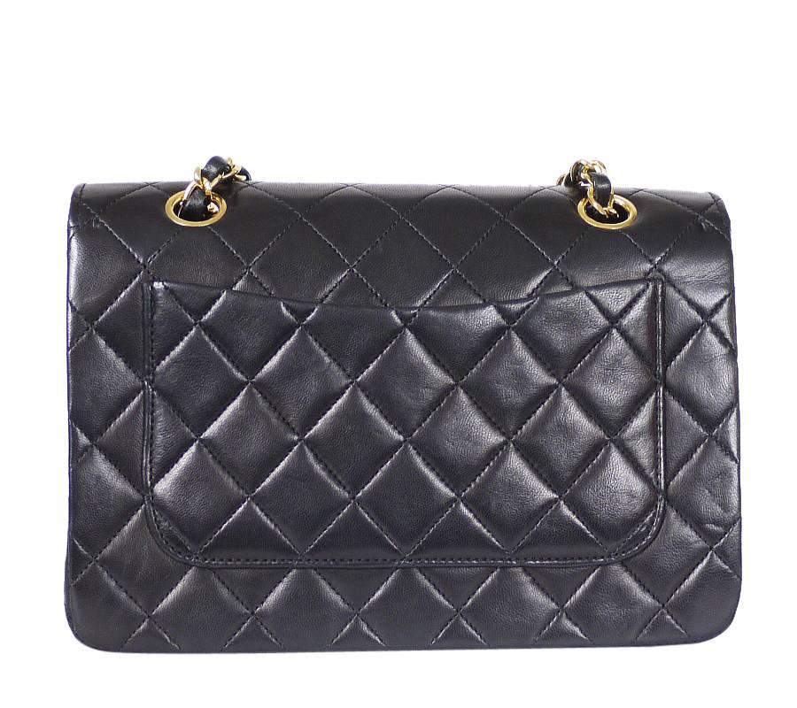 Vintage Chanel Black Lamb Skin Classic Flap Bag. Rare vintage from 1980s. This beautiful Chanel bag has sliding chain and it makes the bag can be carried over your shoulder or on your elbow.

    Hardware : Gold
    Comes with : Authenticity