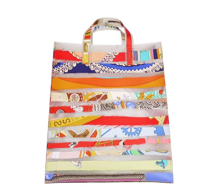 Extremely rare, Hermes Silk scarf strips tote bag. This is the Louvre Museum limited edition from 2004-2005.These unusual, colorful bags designed by Luisa Cevese for Hermes boldly mix two seemingly contradictory materials; Silk and Polyurethane. The