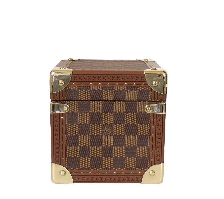 This cube-shaped case holds jewellery, photos or CDs and comes in Damier canvas. It is decorated with smooth chocolate-coloured leather and features an S-lock for added security.

- Damier canvas, chocolate-coloured trimmings, microfiber lining and