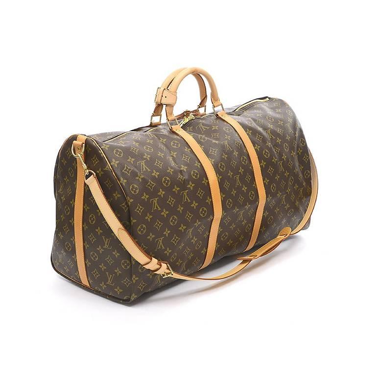 Louis Vuitton Monogram Keepall 60 Bandouliere Travel Bag in excellent condition. An icon since the appearance in 1930, the Keepall embodies the spirit of modern travel. Light, supple and always ready for immediate departure, the bag lives up to its