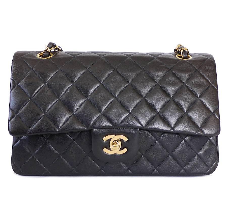 Chanel black lamb skin 2.55 double flap classic in excellent condition. Features a double flap with multiple storage compartments. Vintage Chanel bag from 1990's. Kept in excellent condition. Lambskin quilt is still very soft. Great pre-loved