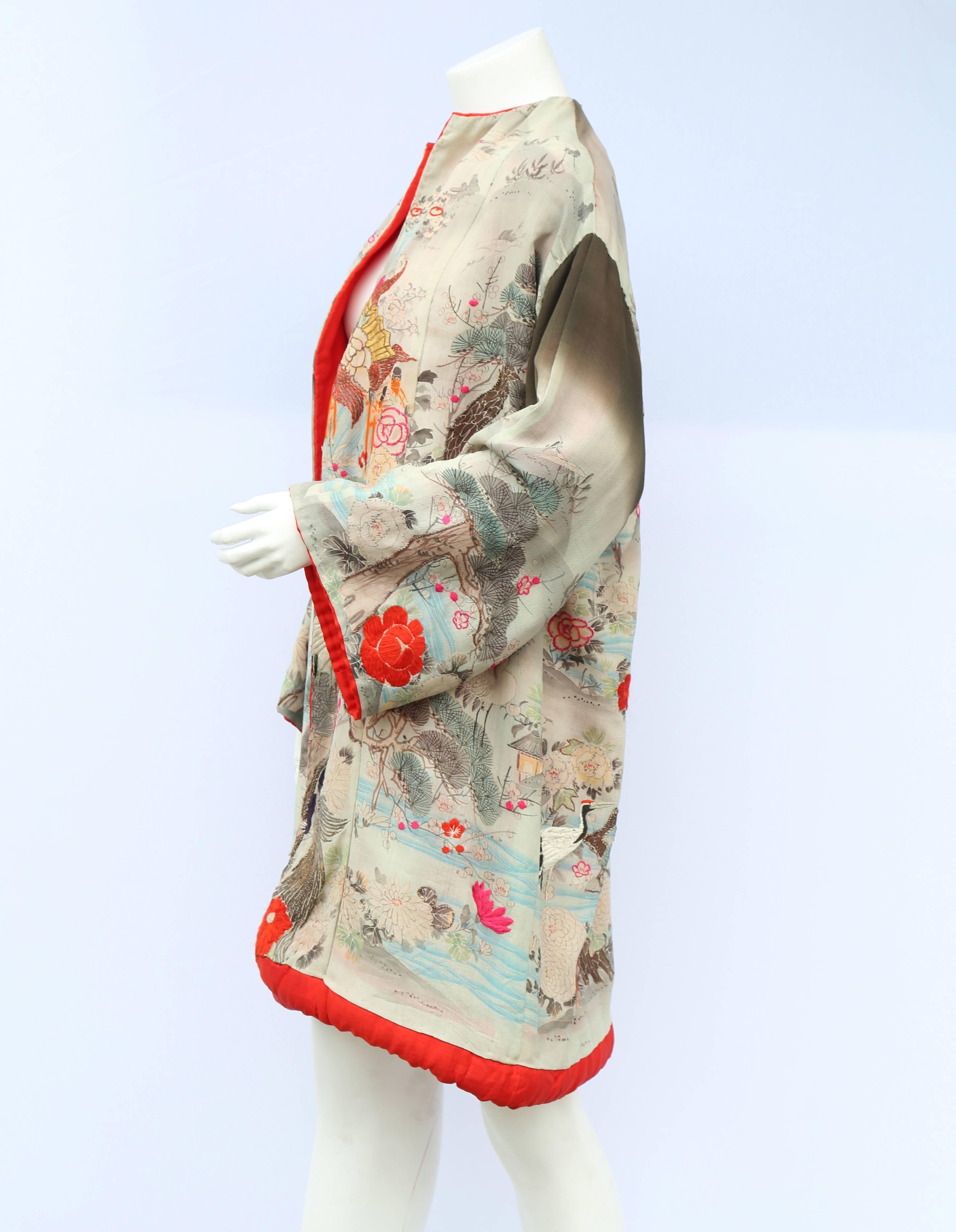 A vintage 1920s printed water colour silk kimono with bright red lining and embroidery throughout 

Measurements taken flat in inches
Bust – 26
Waist – 26
Hips - 26
Length – 36
Sleeve length – 18 
Sleeve circumference 20 inches
