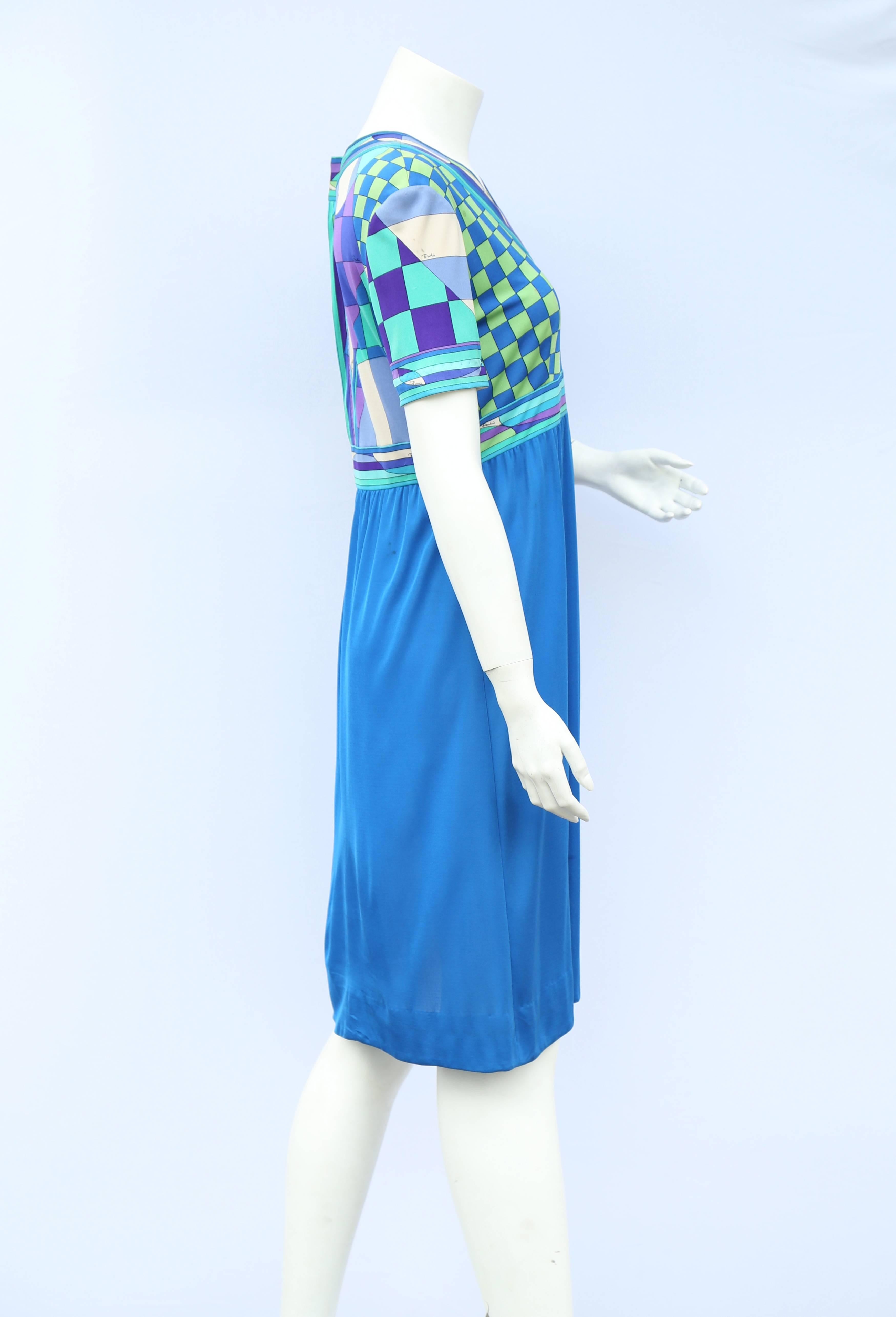 A vintage 1960s vibrant blue and classic pucci print silk jersey dress has a zip on the side and back creating a fitted bodice and aline skirt.

The skirt has a few tiny marks 

Measurements taken flat in inches
Bust – 18inches
Waist –