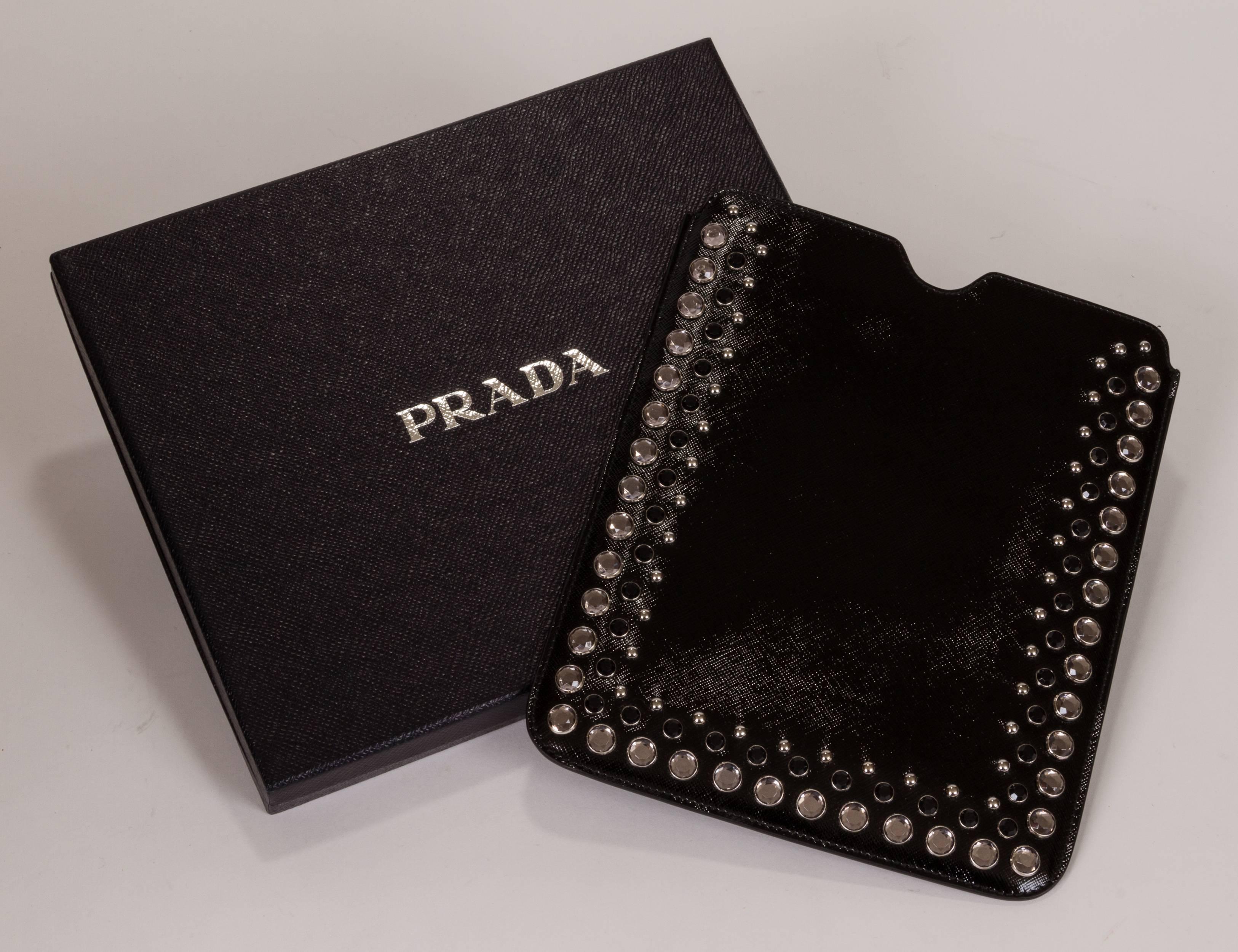 New with tags, bejeweled ipad cover case. Glossy saffiano leather in black white with gray jewels.Butter lambskin leather interior. Gold tone Prada lettering. Comes with original box, warranty and tag.