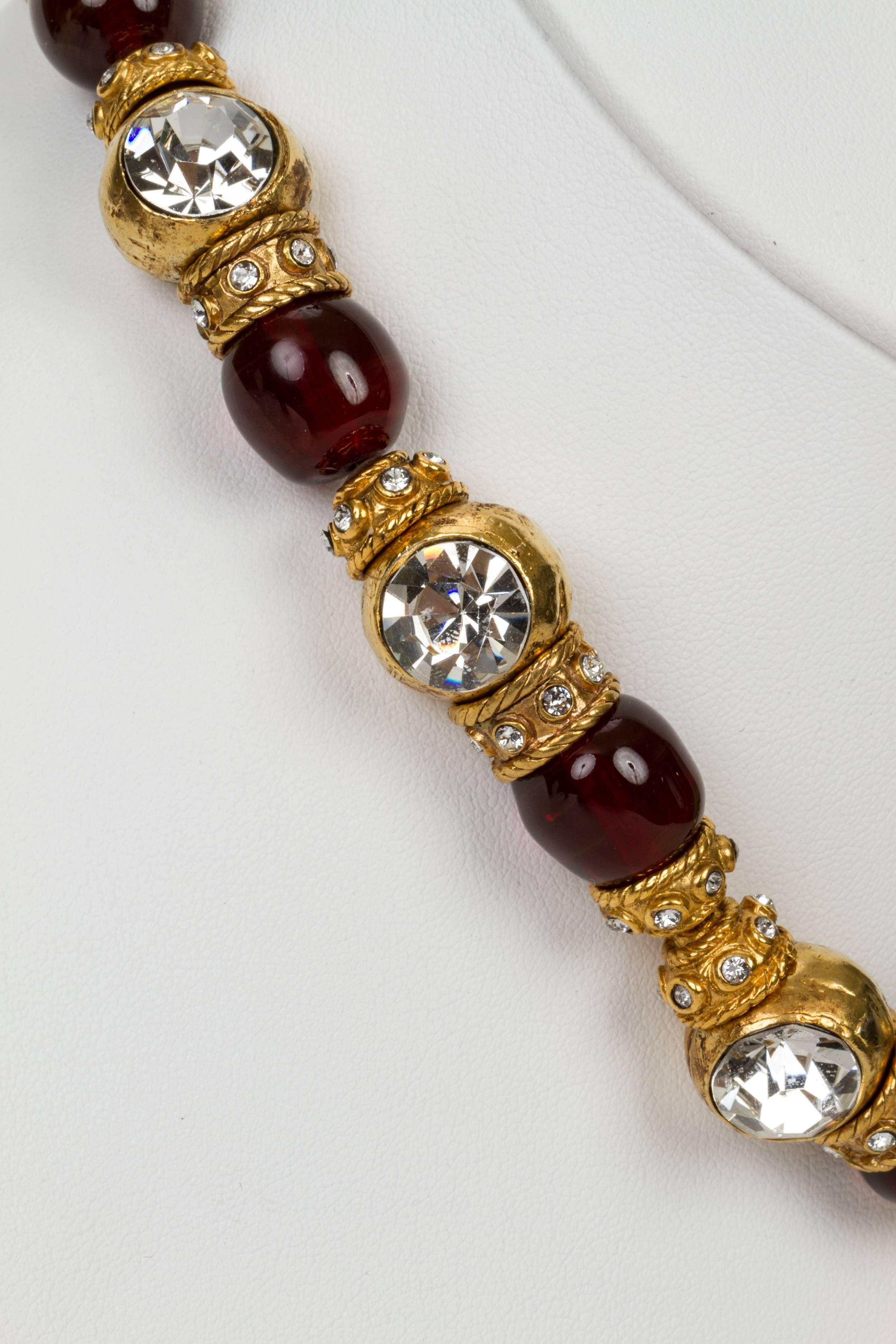 1970s Chanel oversized red gripoix and goldtone metal bead necklace with large crystal and red glass dangling charm. From a private collection and is in pristine condition. Comes with the original vintage Chanel box.