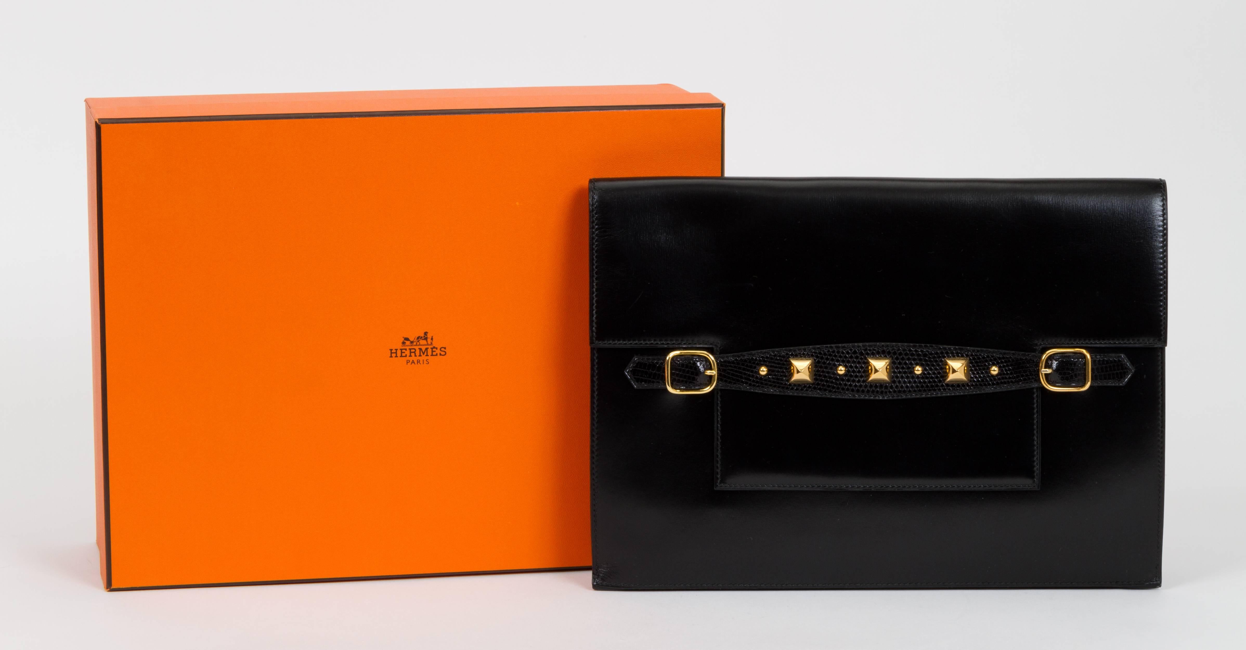 Hermès black box calf and lizard clutch with gold tone studs details. Excellent condition. Date stamp N for 1984. Comes with original box.
