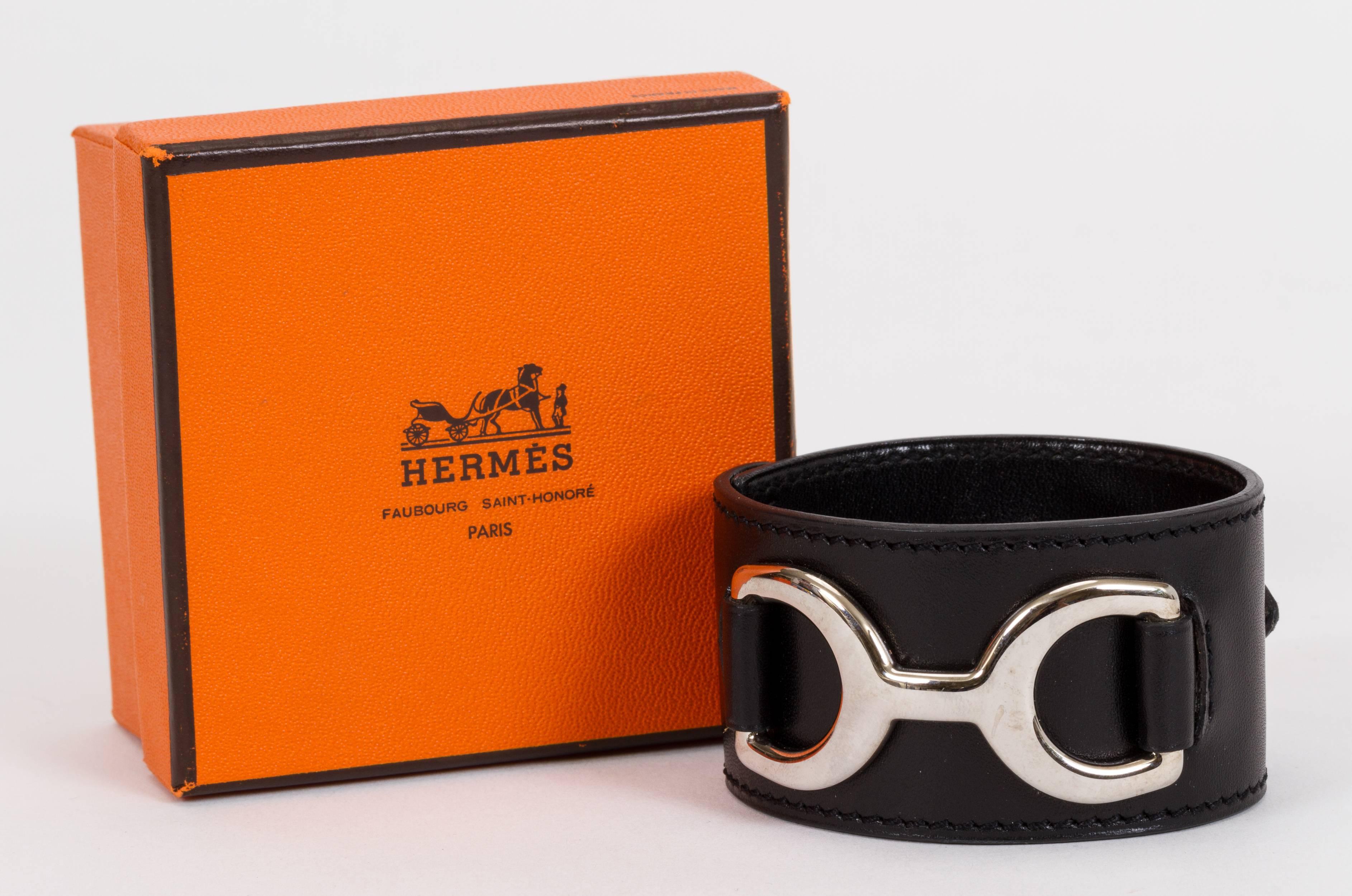 Hermès black leather and palladium hardware mors wide adjustable cuff. Size medium. Comes with original box. Stamped H for 2004. Minor scuffs on leather and hardware.
