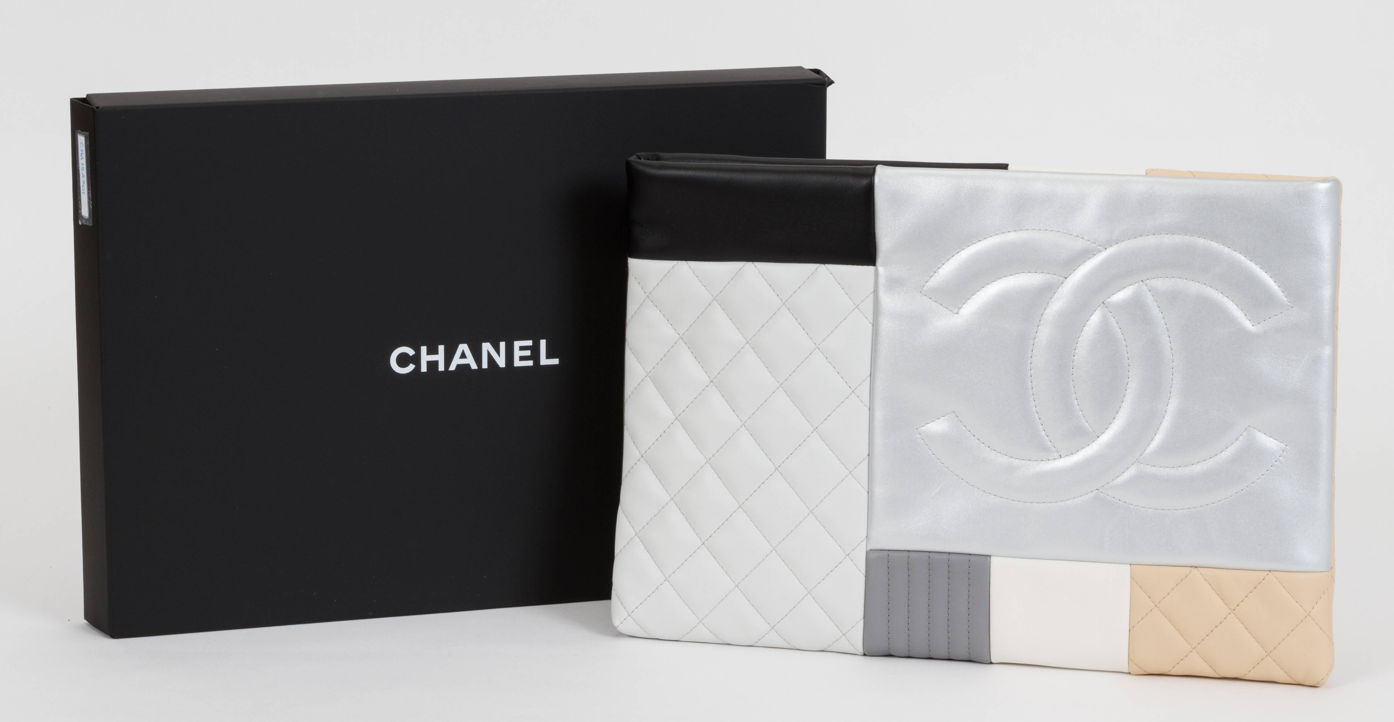 Chanel large clutch with patchwork quilting. Multicolored lambskin combination with dangling tassel. Brand new in box with booklet, hologram, dust cover, and box.
