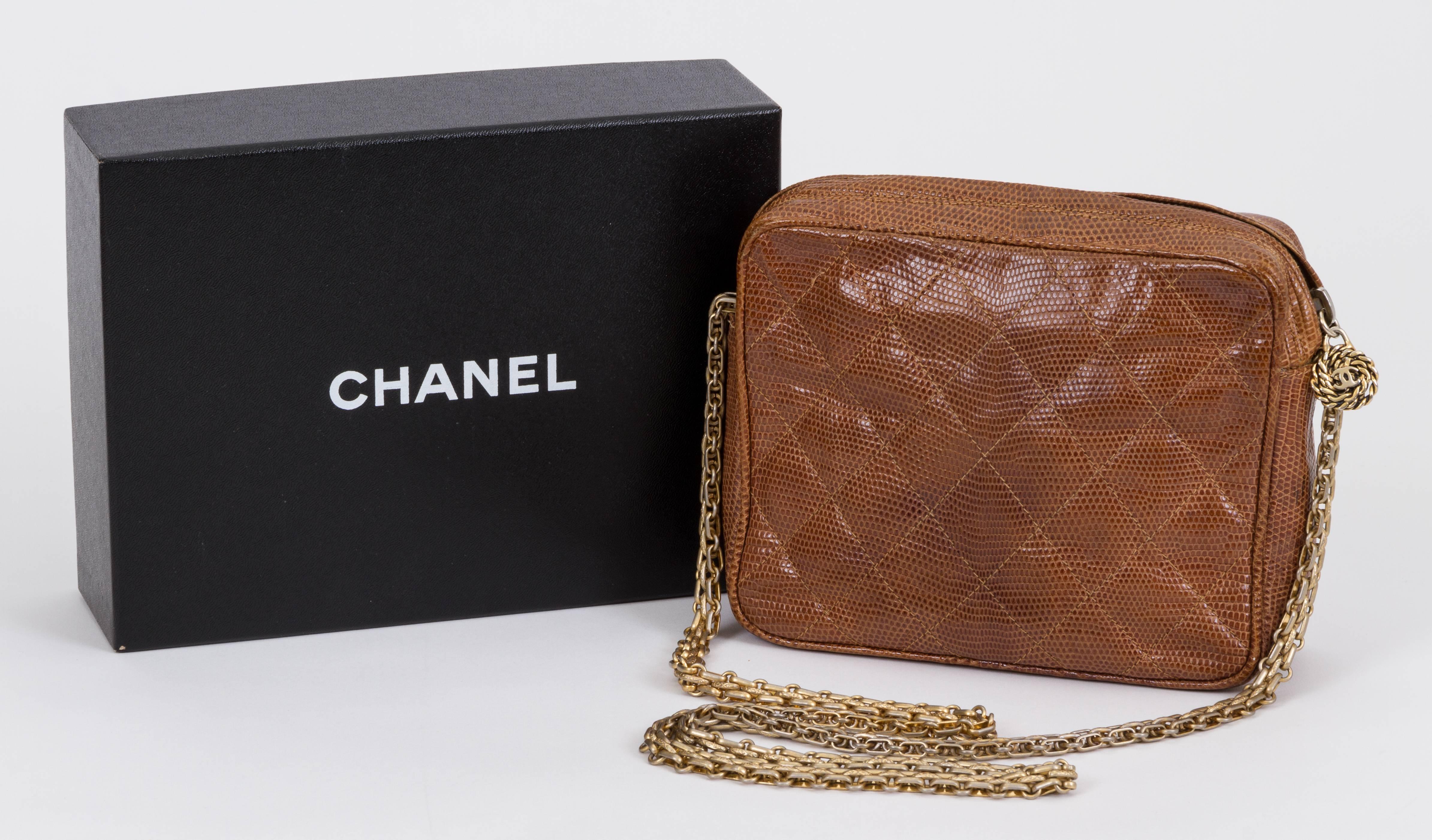 Chanel brown quilted lizard skin shoulder bag. Comes with hologram and original box. Repair to cut on side. Some stitching is loose.