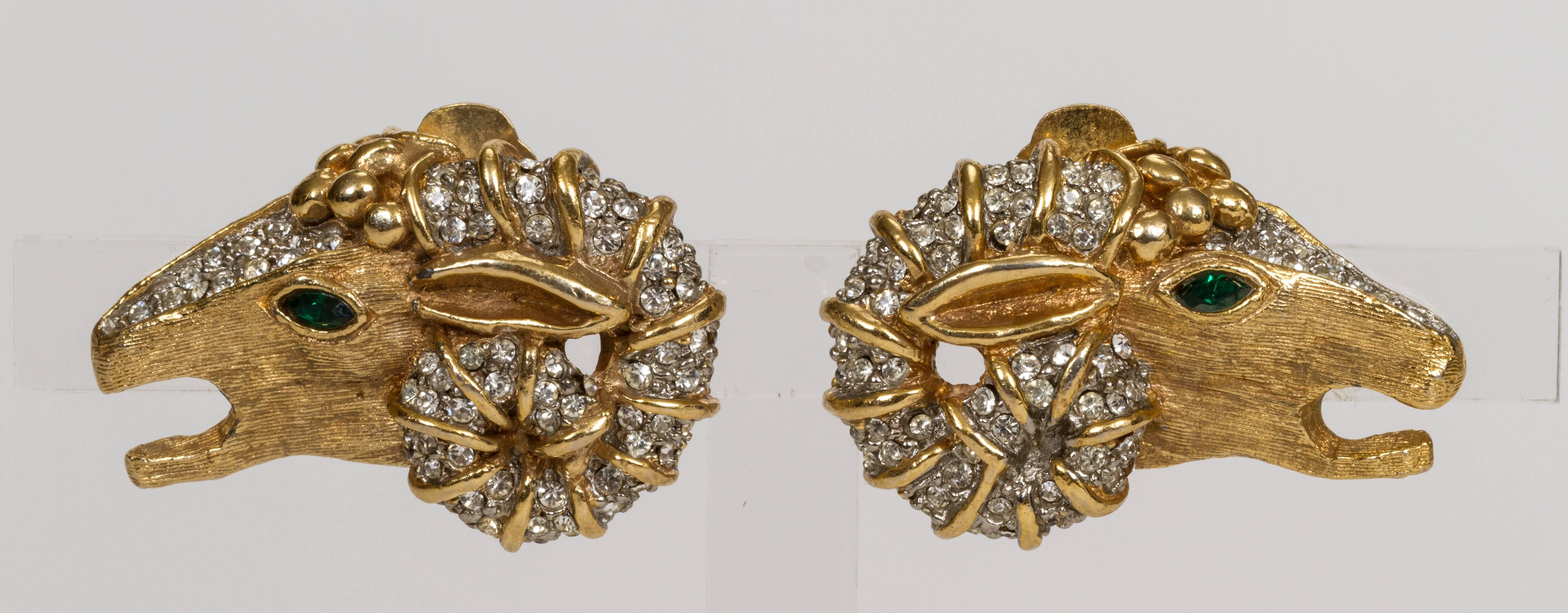 Kenneth Jay Lane iconic gold plated rhinestone clip earrings with emerald class cut eyes. Excellent vintage condition with minor wear. 1960s collection.