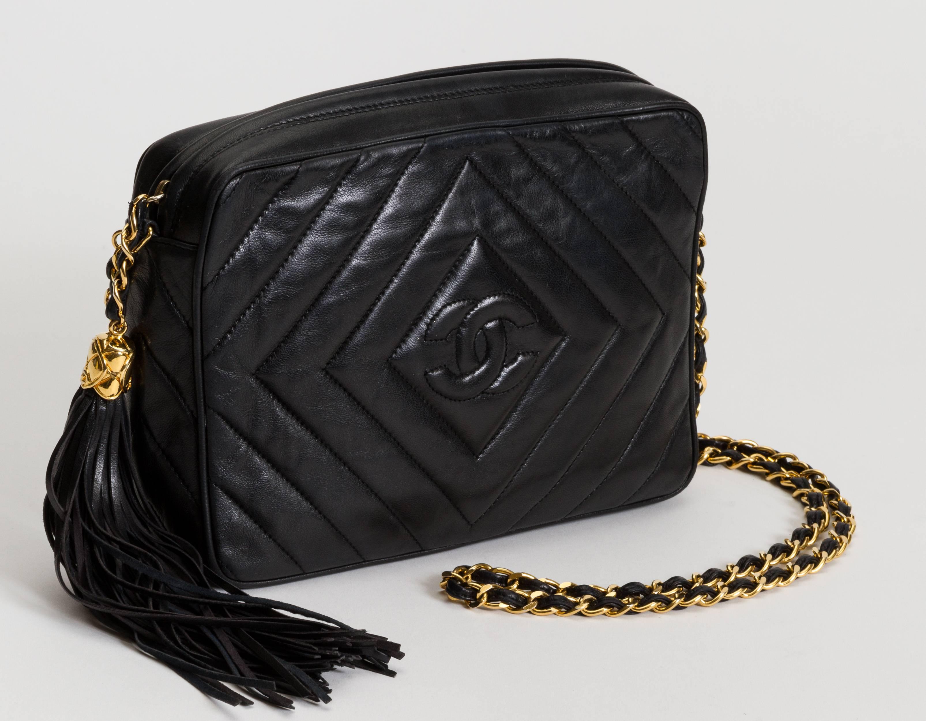 Chanel black lambskin chevron camera bag with dangling tassel. Shoulder drop 21