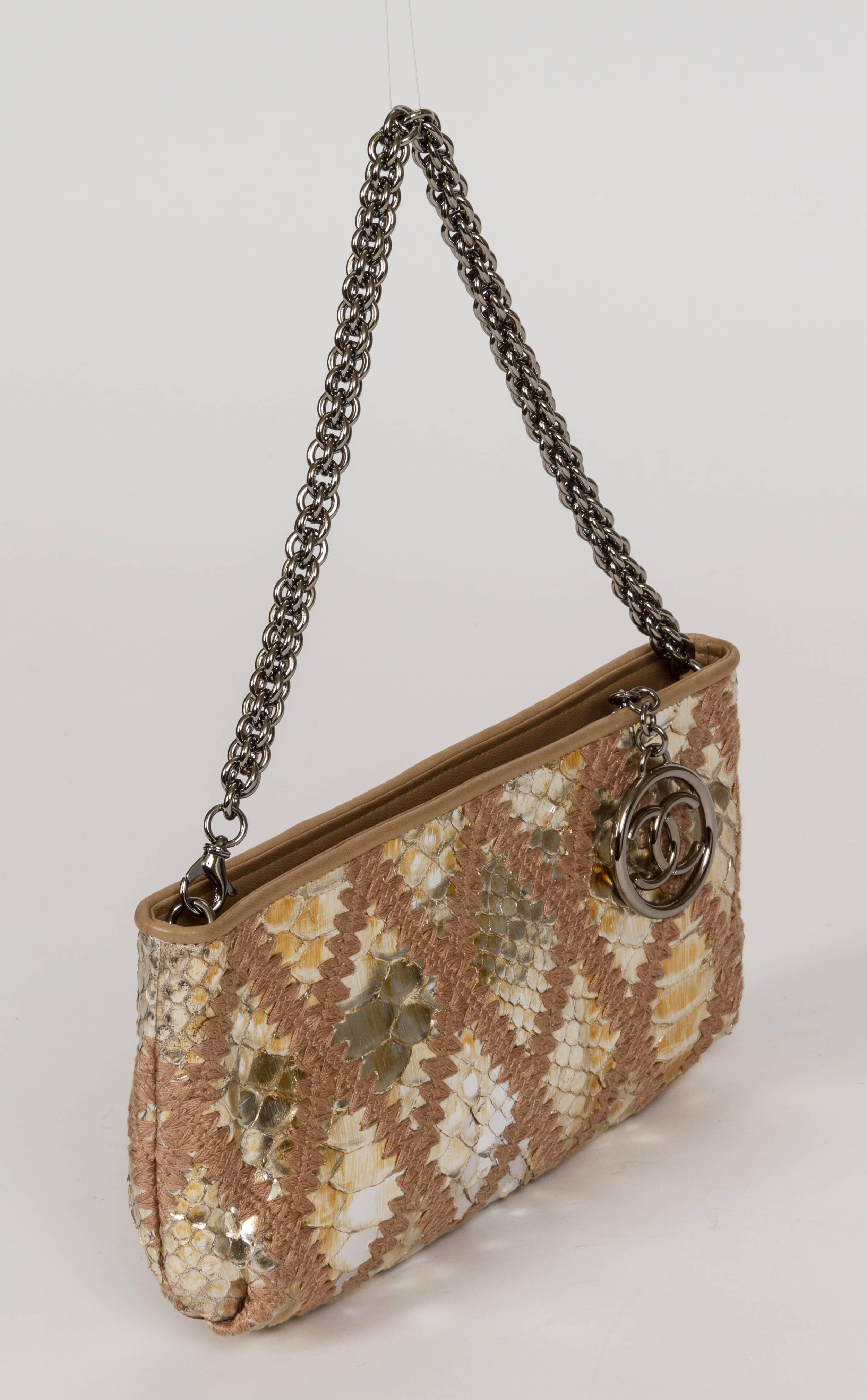 Chanel evening bag/clutch in gold python leather and gunmetal hardware. Detachable shoulder strap that drops 7.5