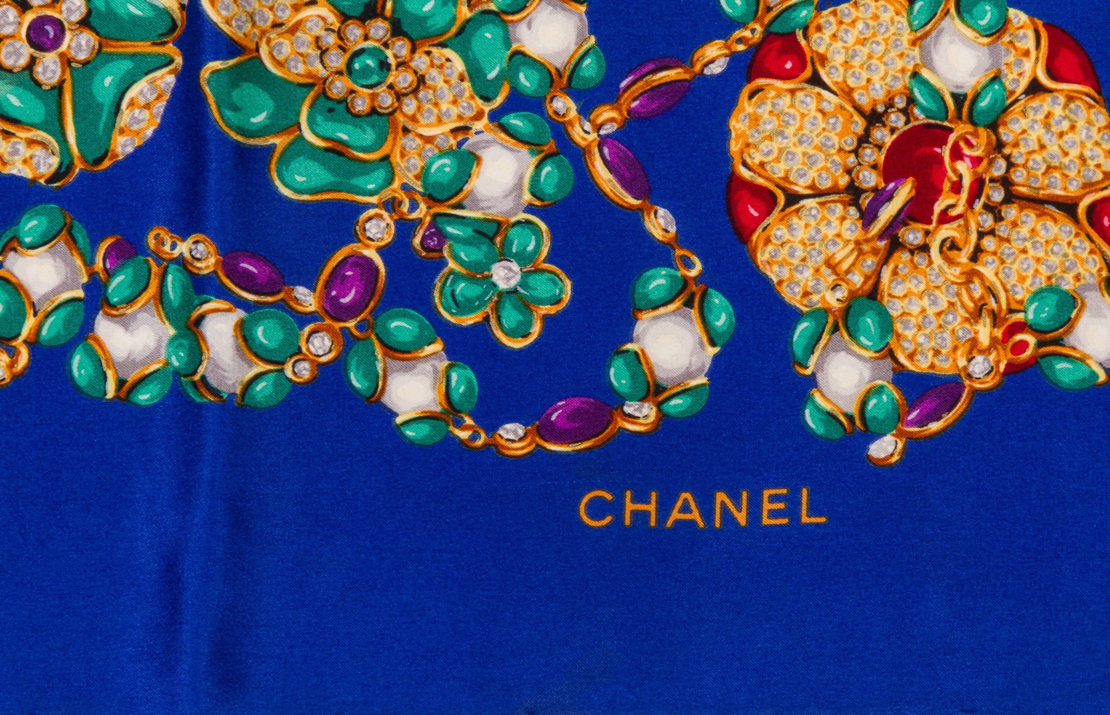 Chanel electric blue silk twill scarf with multi colored jeweled stones. Hand rolled edges. Does not include box. 