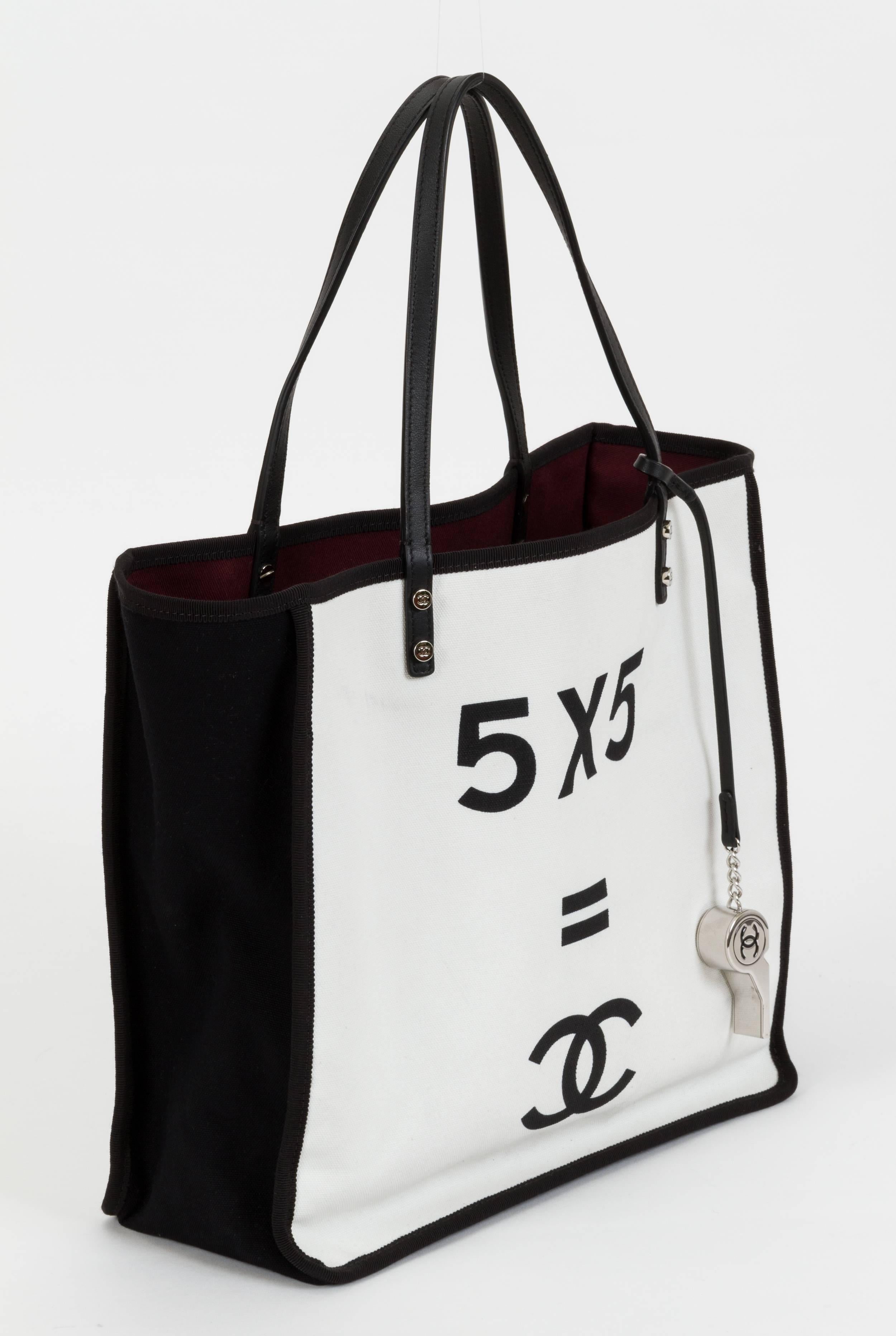 Chanel black-and-white canvas canvas tote with whistle charm. Comes with hologram, booklet, ID card, and original box. Handle drop, 7
