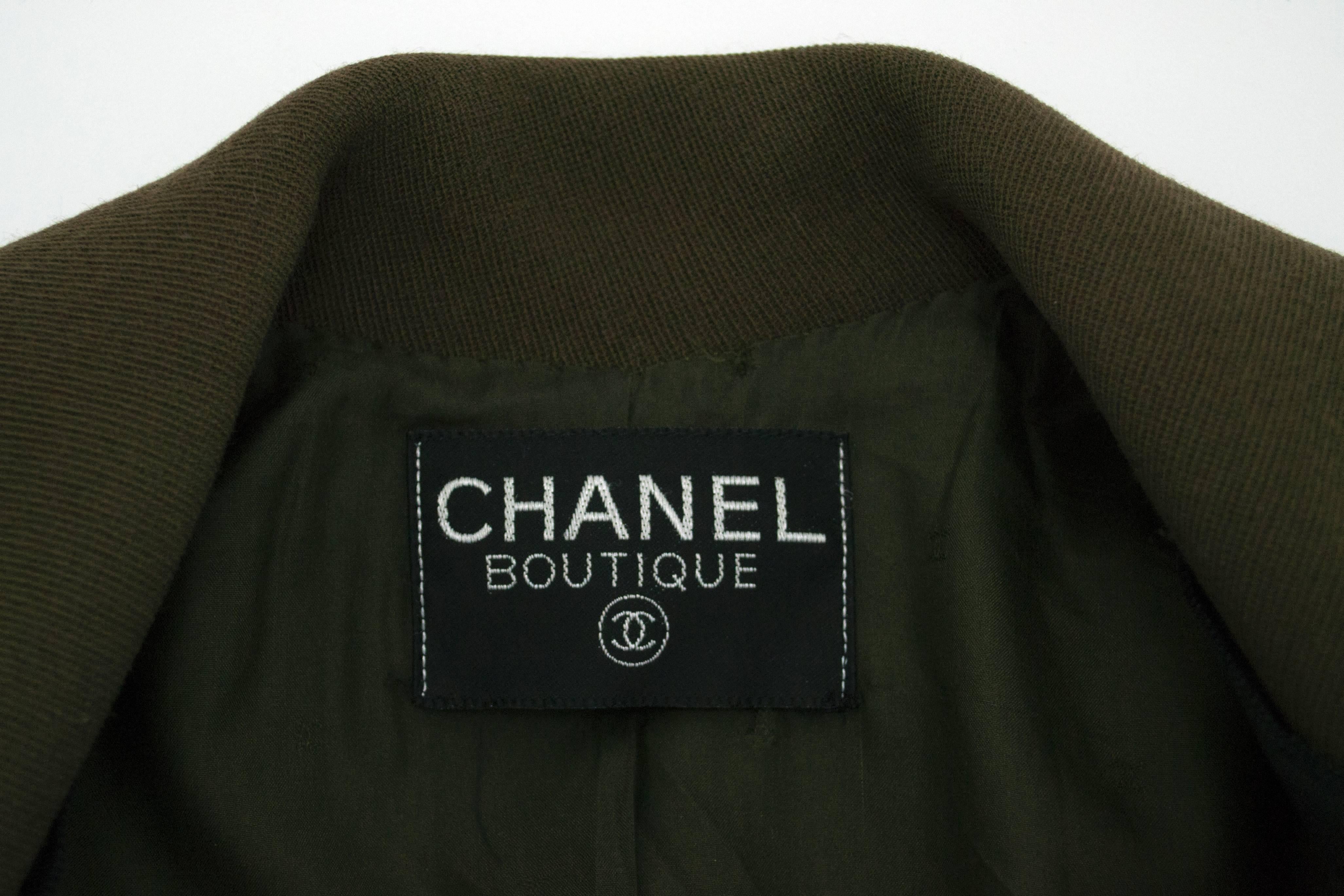 Chanel wool blend olive colored single breasted jacket with grosgrain black ribbon detail. Front hip pockets and black ribbon buttons with gold CC logo detail. Lined in signature olive silk CC lining. Sizing tag is not included. Please confirm