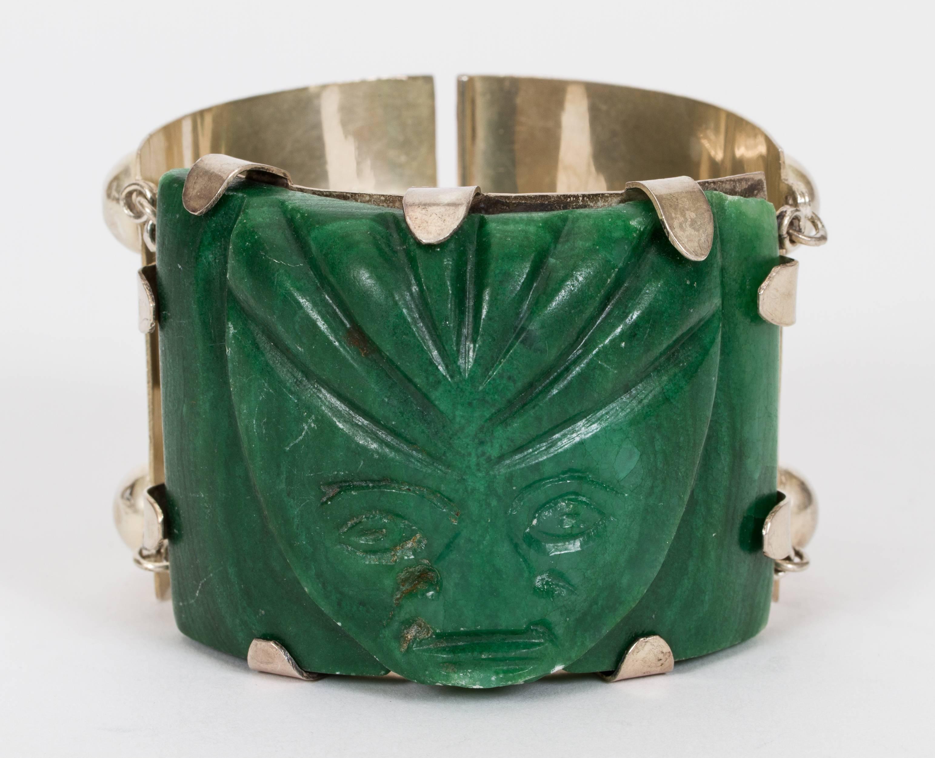 Mexican sterling silver hinge clasp heavy weight bracelet with ornate carved resin colored jade center with side center stones. Comes in velvet pouch. 