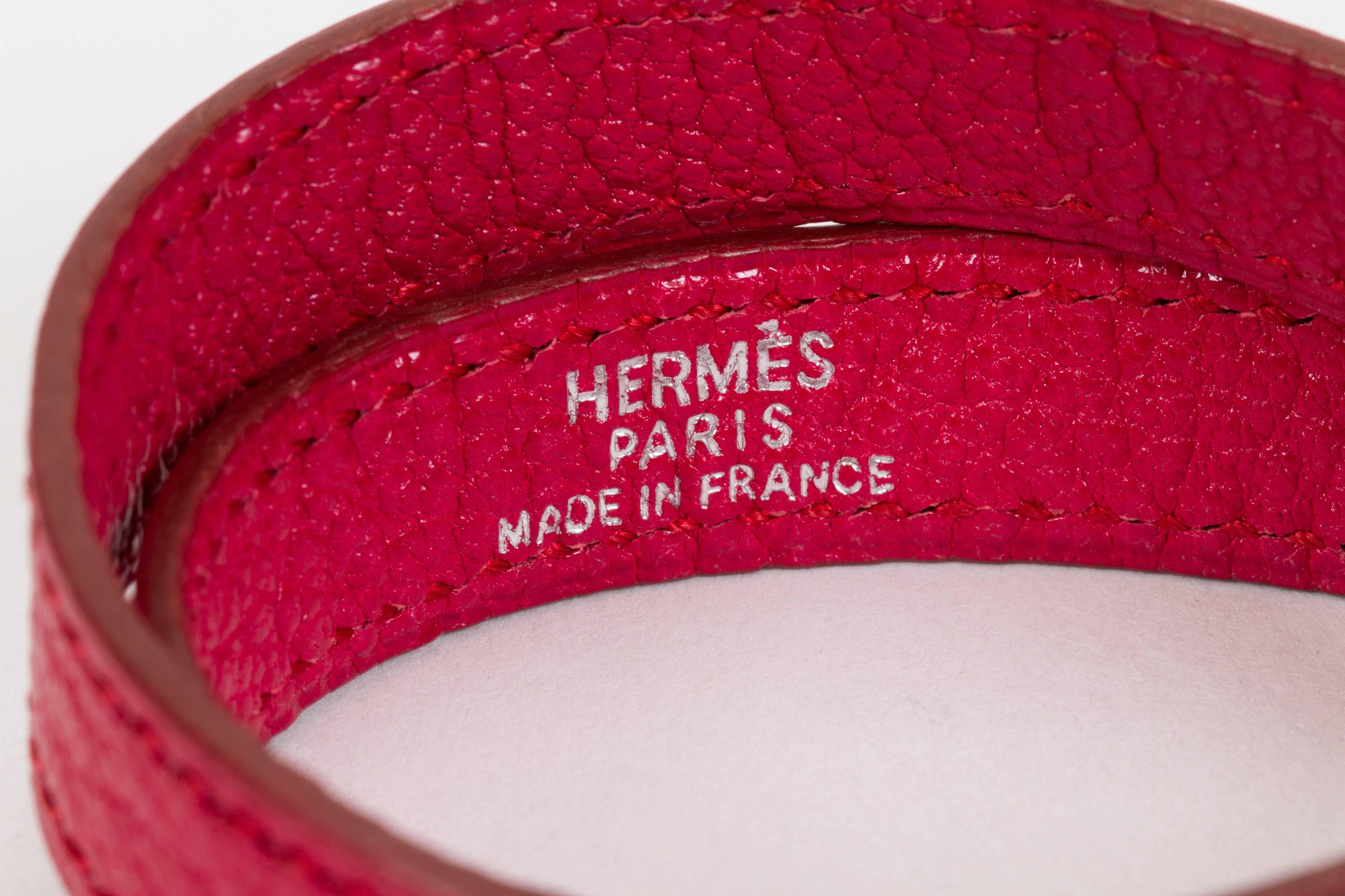 Hermès kelly double bracelet in ruby chevre (goat skin) leather and palladium hardware. Dated I for 2005. Size medium. Comes with original box.