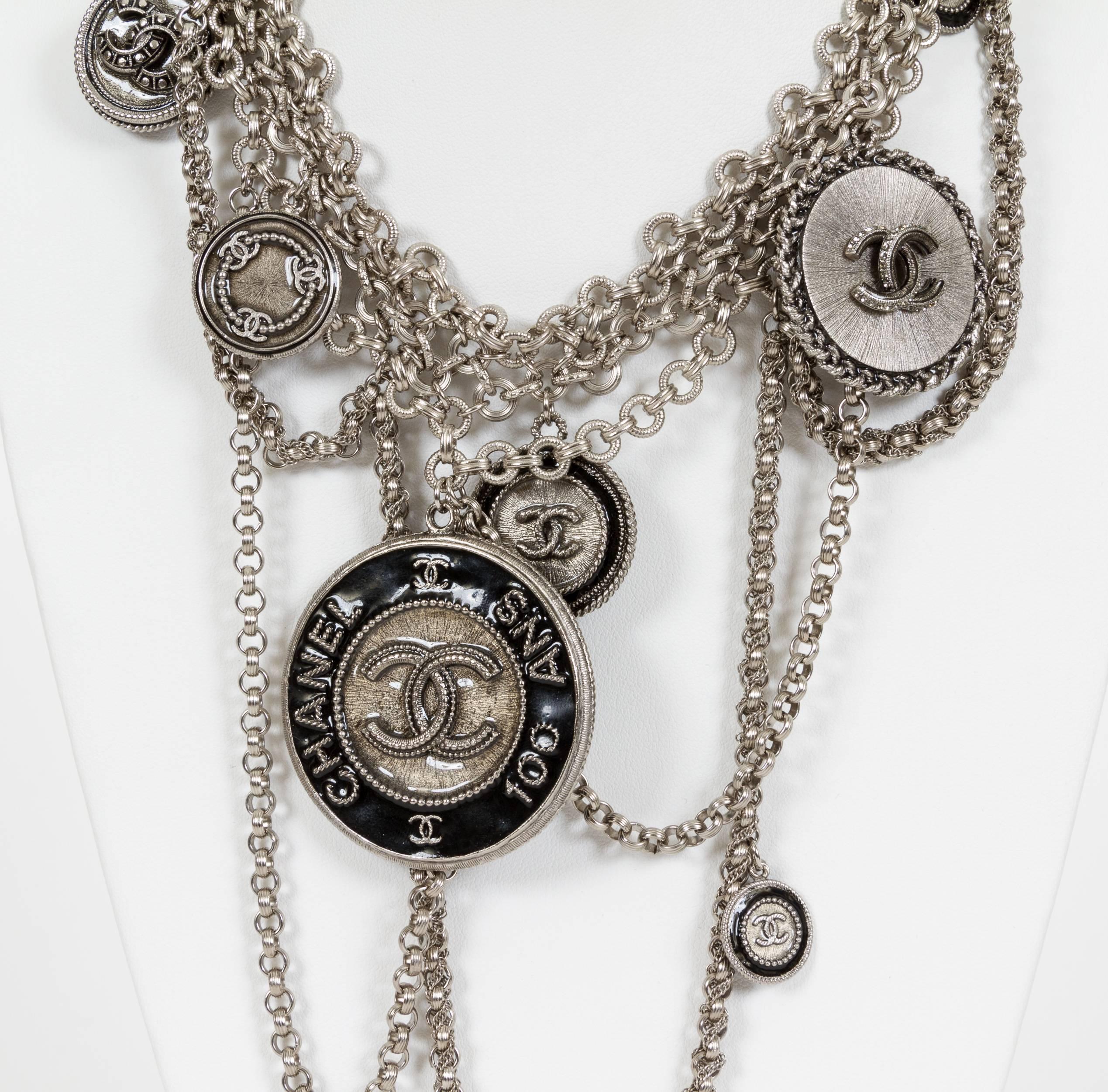 Chanel 2009 100 year anniversary charm necklace. Very rare. Has 7 different logo charms and a multistrand overlapping chain. Comes with original box.