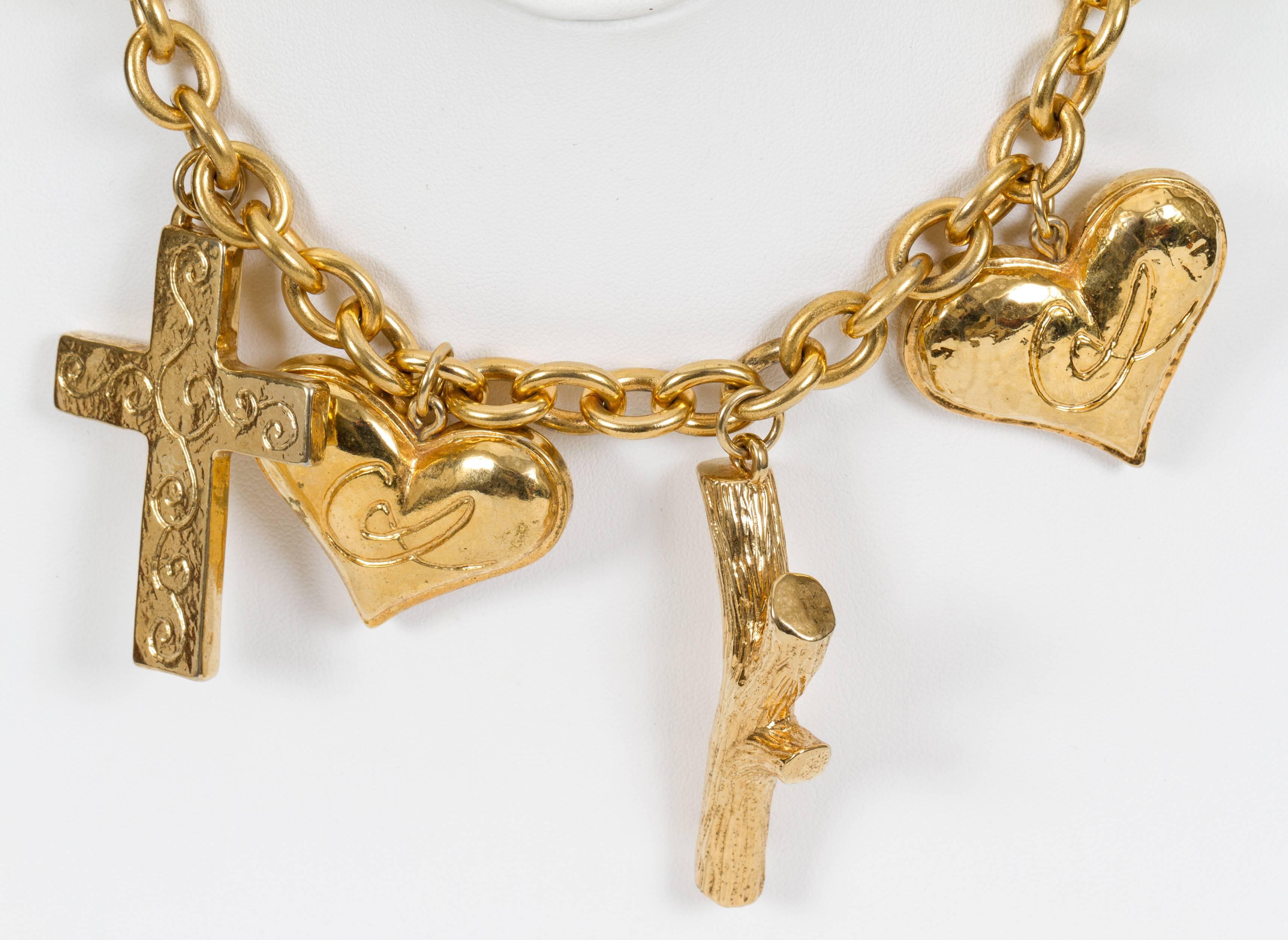 Christian Lacroix goldtone charm necklace. Great condition. Comes with velvet pouch.