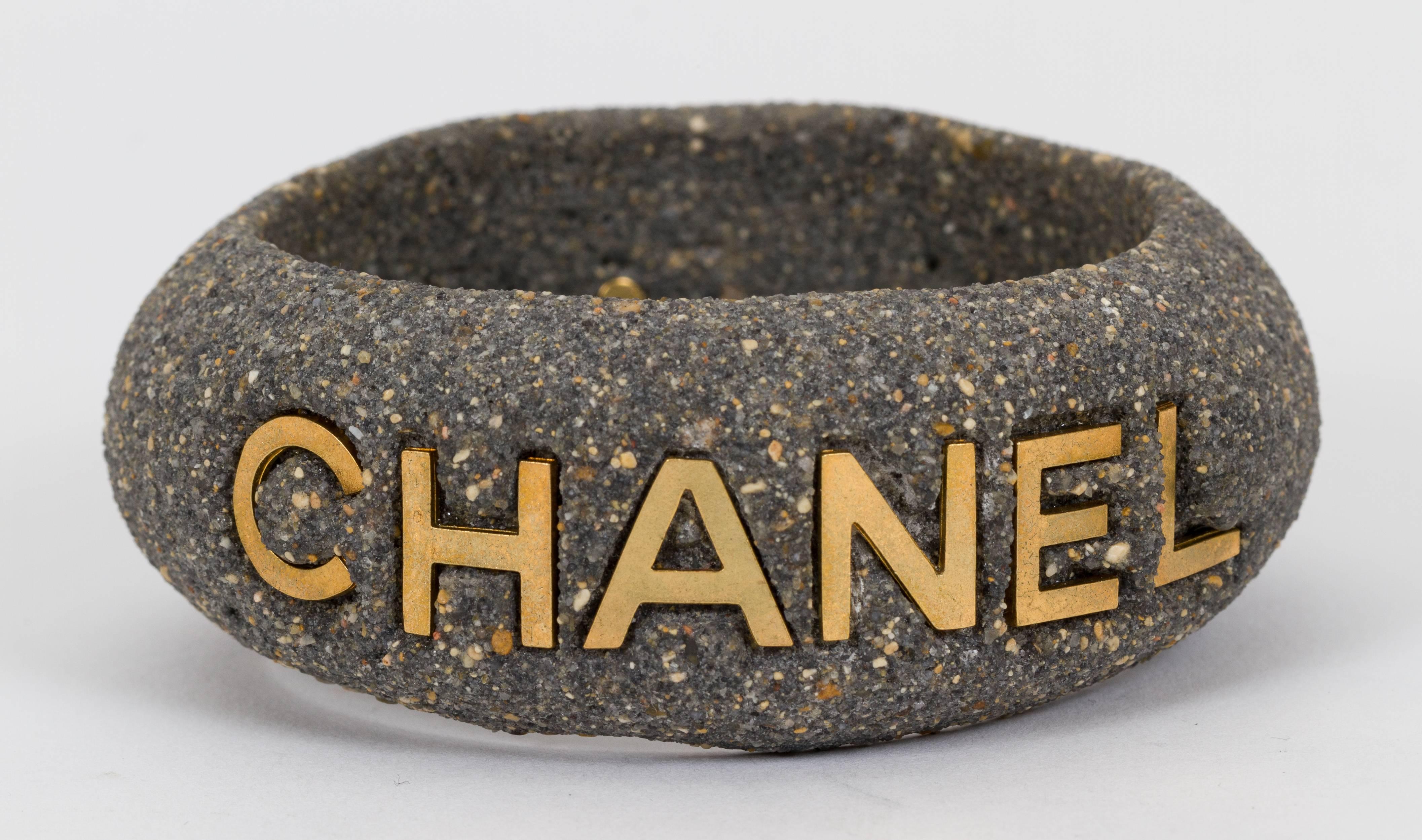 Chanle grey stone carved bangle bracelet with Chanel Paris gold lettering. Collection spring 1994. Comes with velvet pouch. 2.5