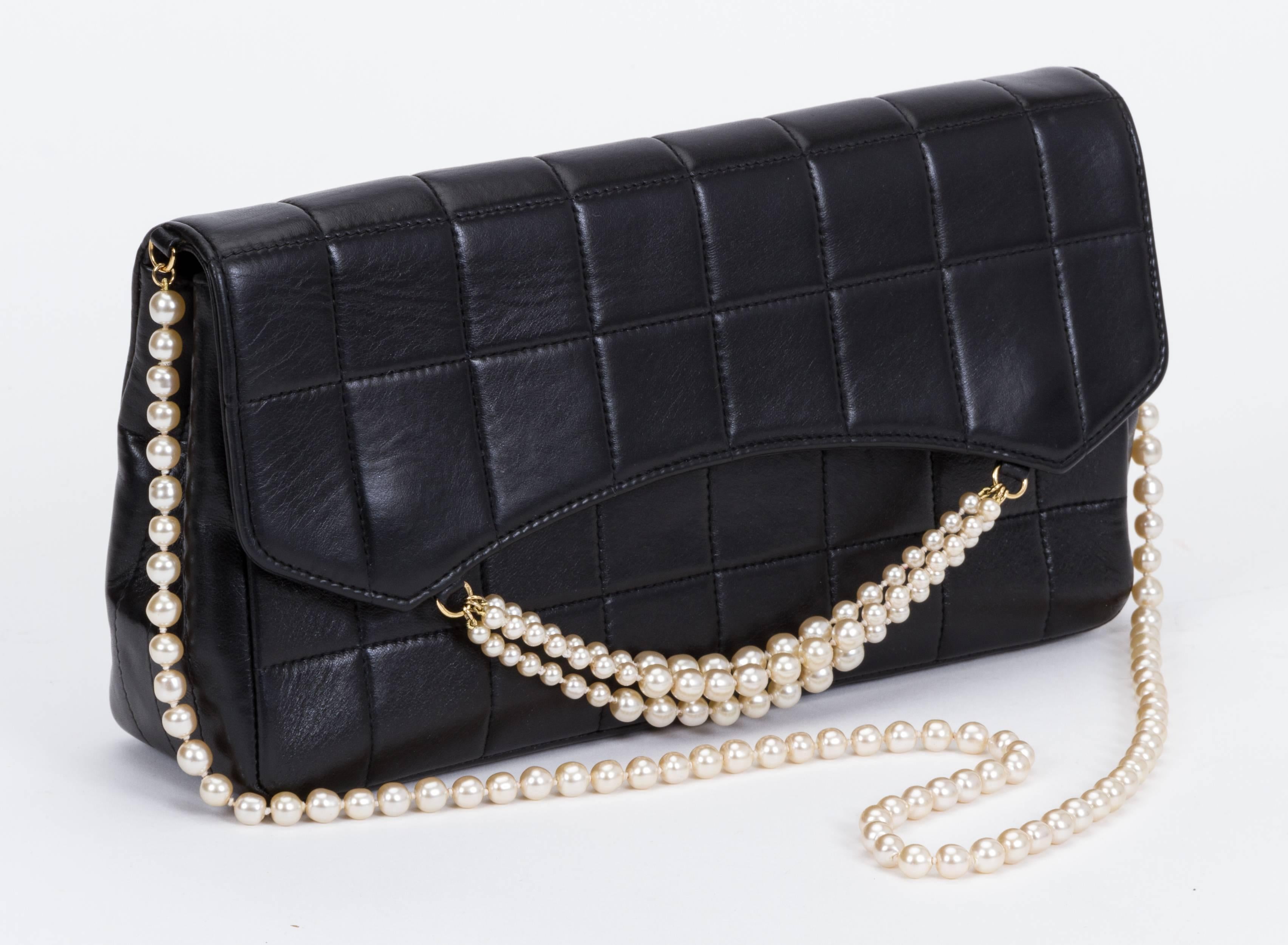 Chanel evening bag in black quilted lambskin with pearl details. Pearl chain shoulder drop 15