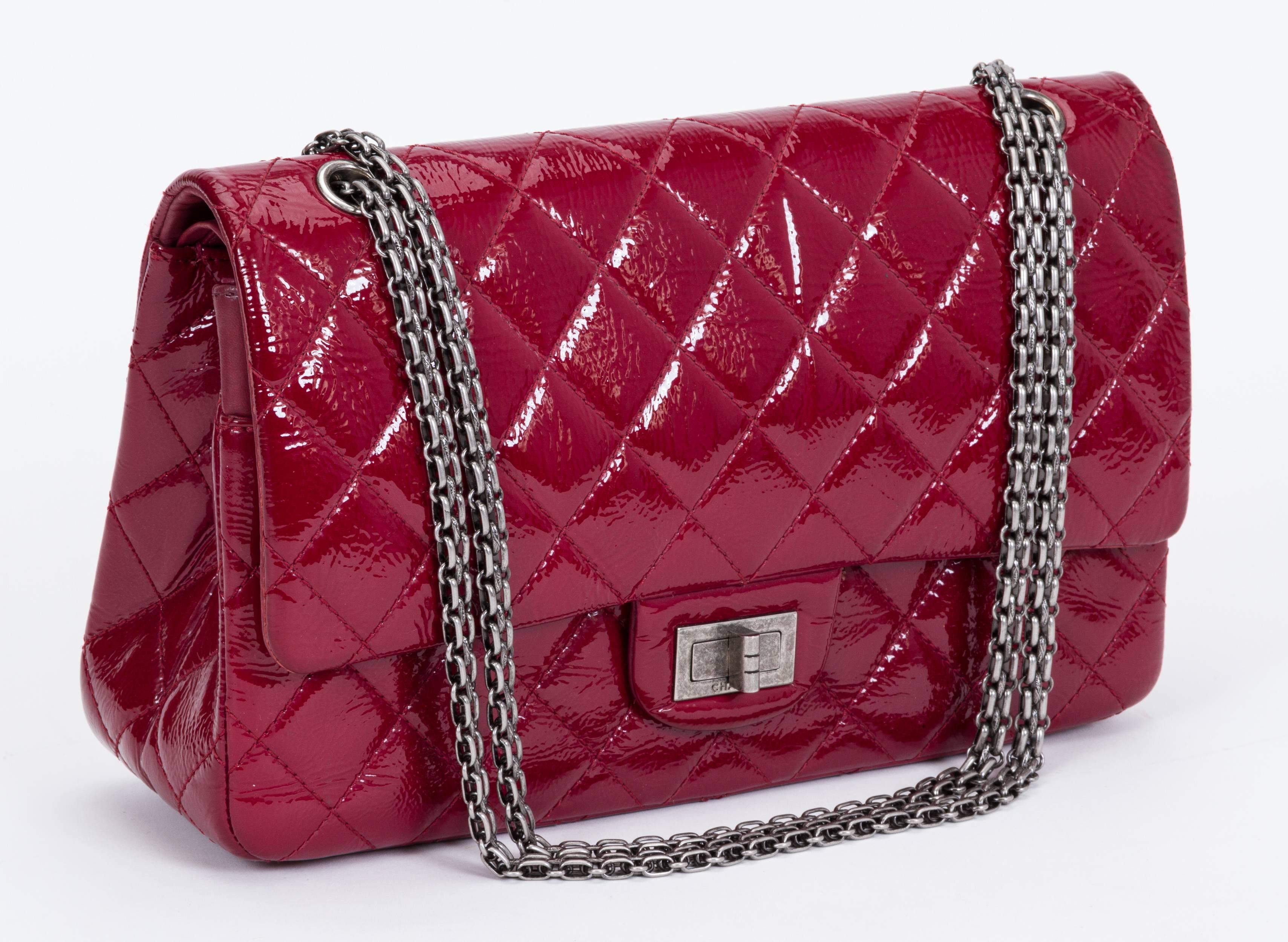 Chanel reissue jumbo double-flap bag in burgundy quilted patent leather with gunmetal hardware. Shoulder drop, 11