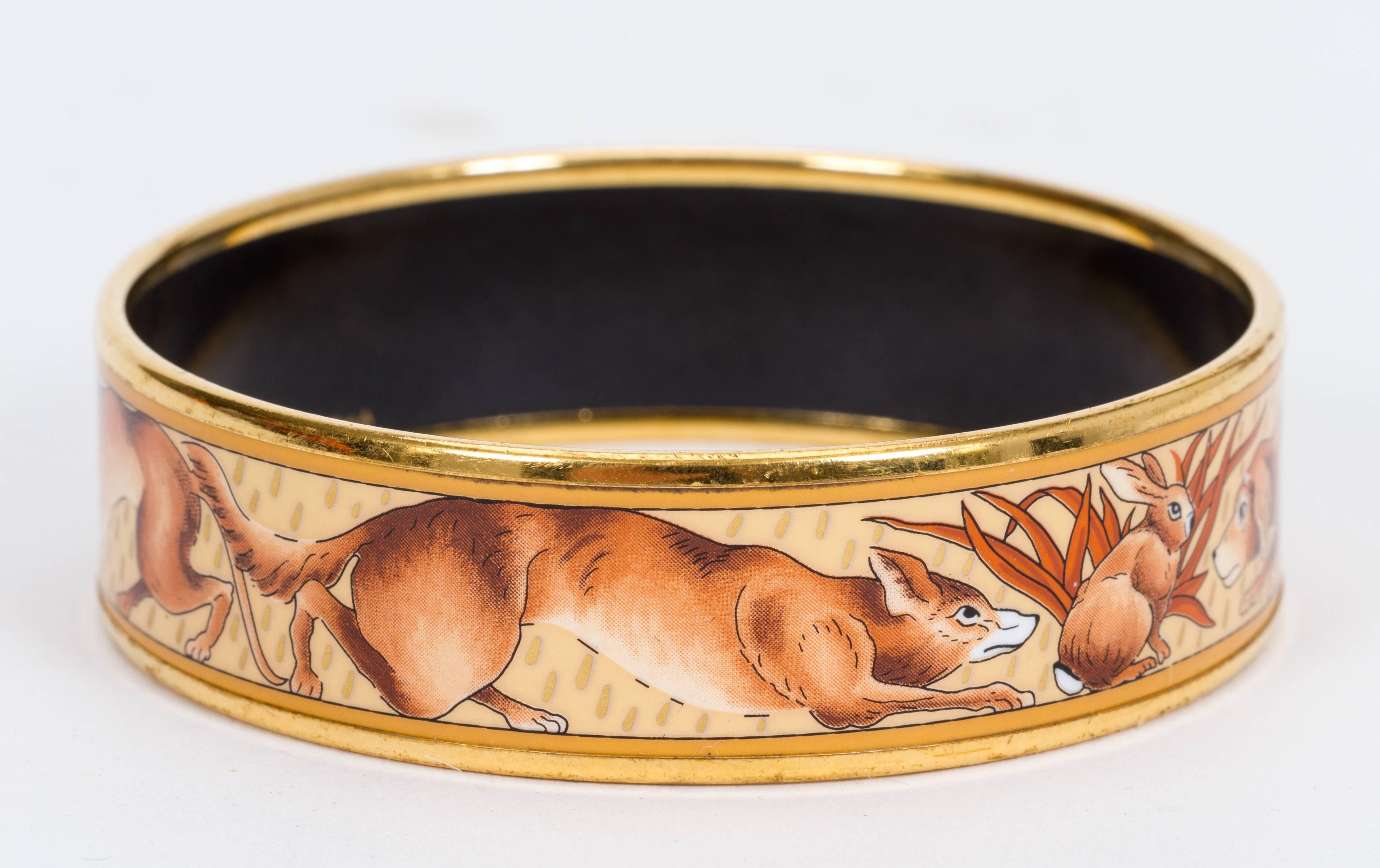 Hermès medium enamel bangle with rabbit and dogs design. Comes with velvet pouch. Medium size. Total length 8 3/4