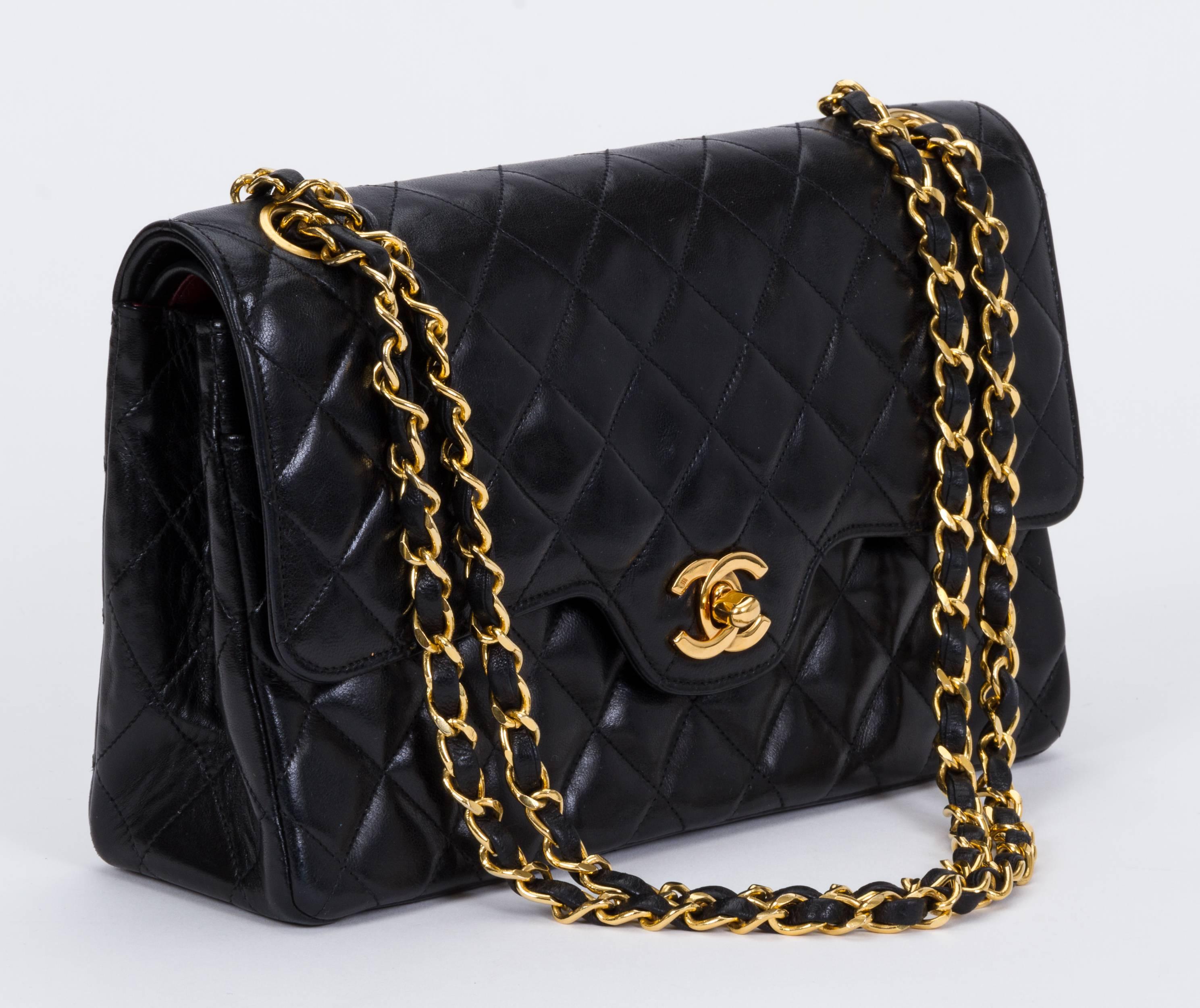 Chanel black lambskin double flap with gold tone hardware. Shoulder drop 9