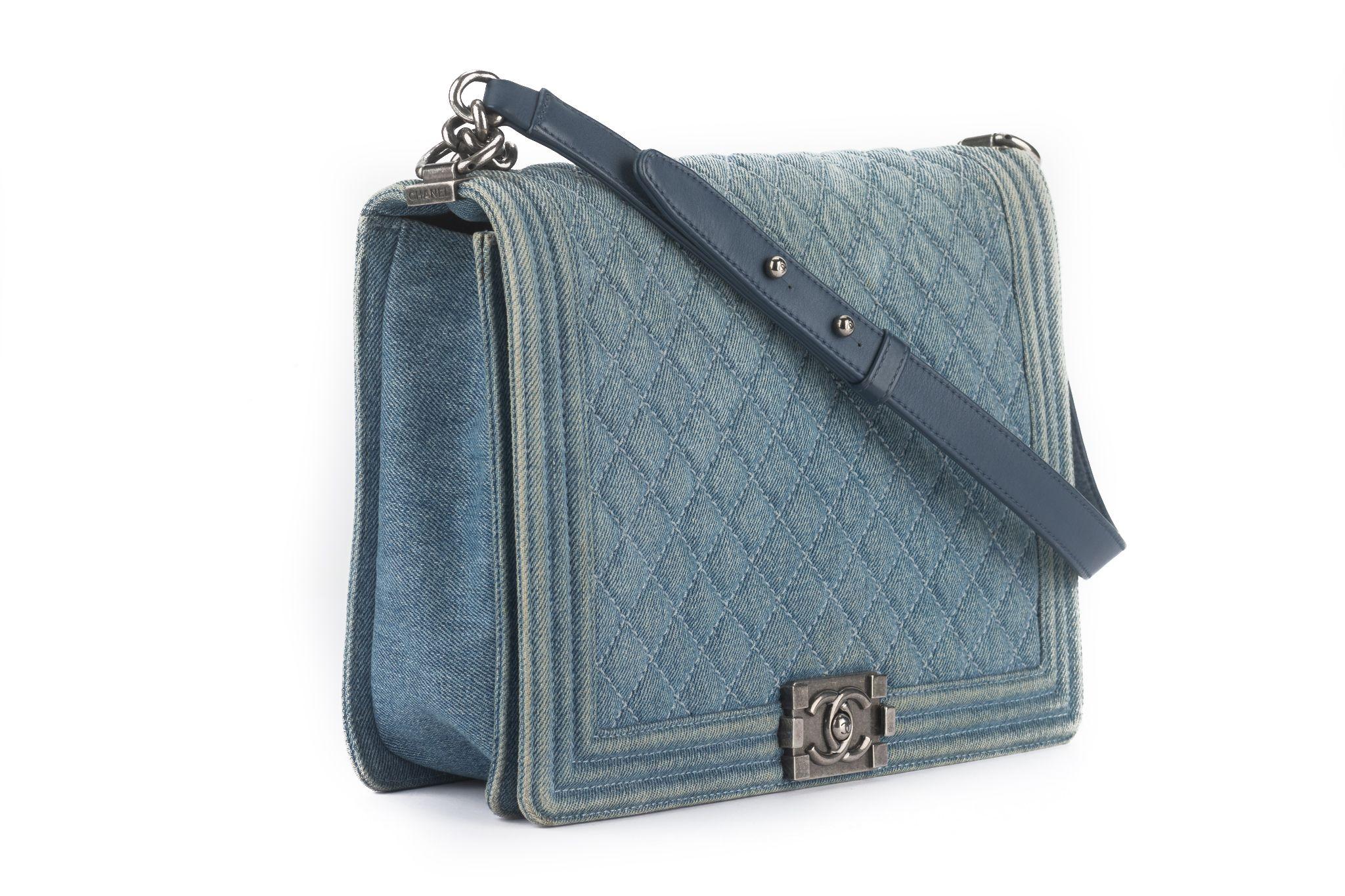Ce Chanel Denim Quilted Large Boy Flap en bleu présente un denim matelassé avec des bords en denim bleu encadrés. Le sac est doté d'une bandoulière à maillons en ruthénium avec un pad et le rabat s'ouvre avec un cadenas Mademoiselle CC Chanel en