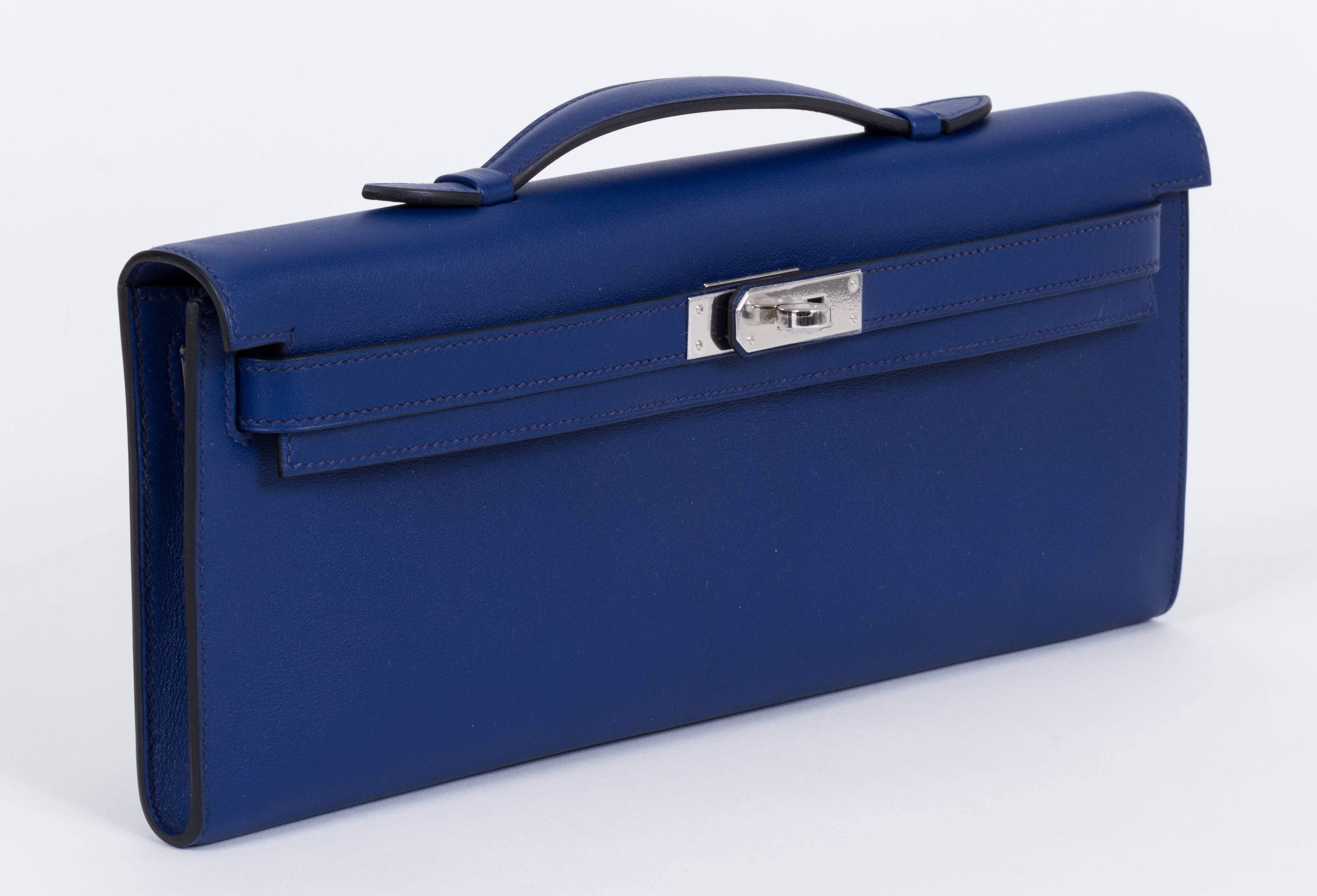 Hermes brand new in box Kelly cut clutch in swift blue sapphire leather and palladium hardware. Plastic still on hardware, never worn.
Dated X for 2016, comes with felt, dust cover, box, ribbon and shopping bag.
Measurements 12.25