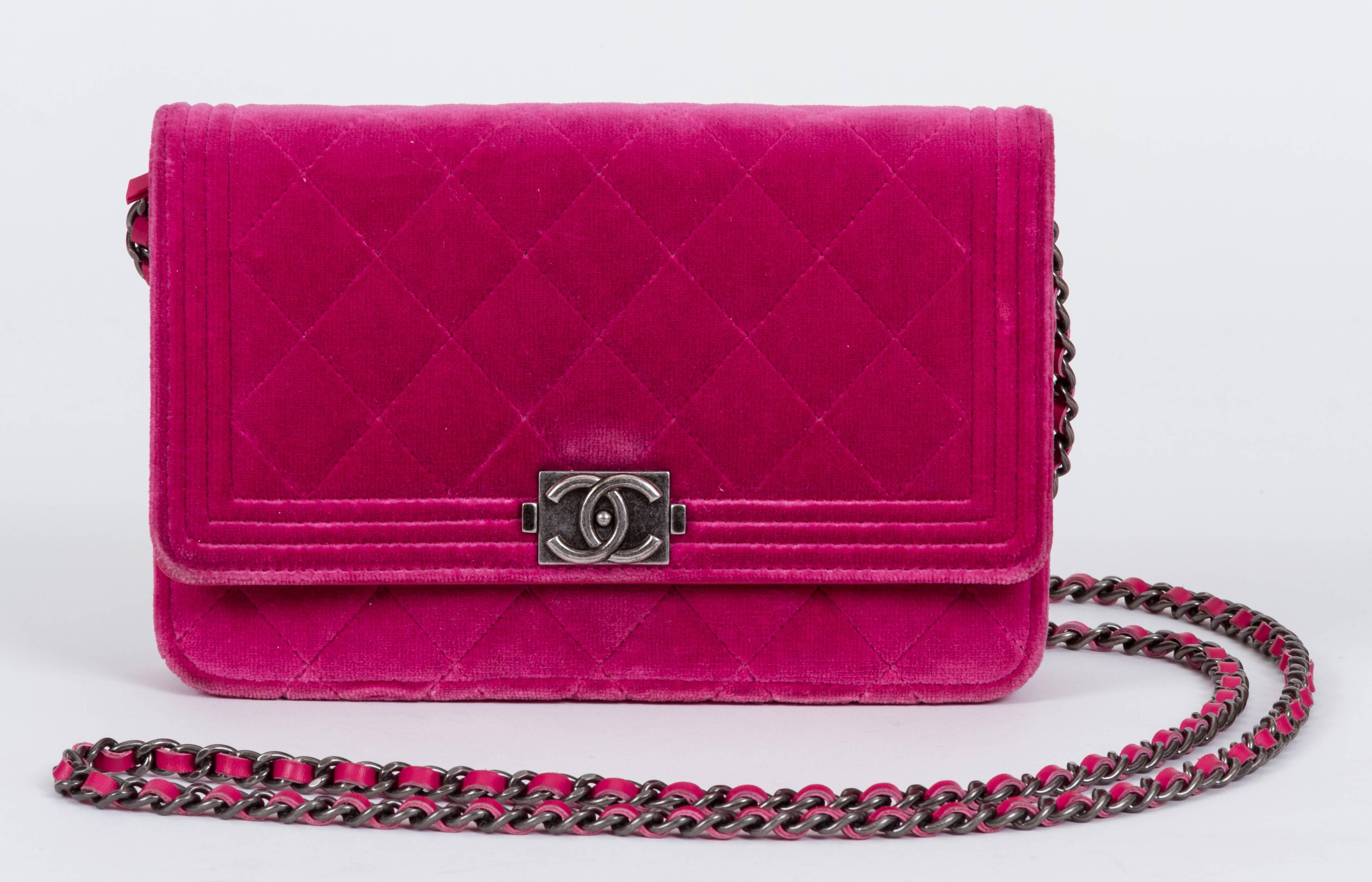 Chanel fuchsia velvet quilted boy wallet on a chain with gunmetal hardware, fuchsia leather lining. Can be worn as a clutch or as a cross body. Minor wear on corners. Measurements 7.5